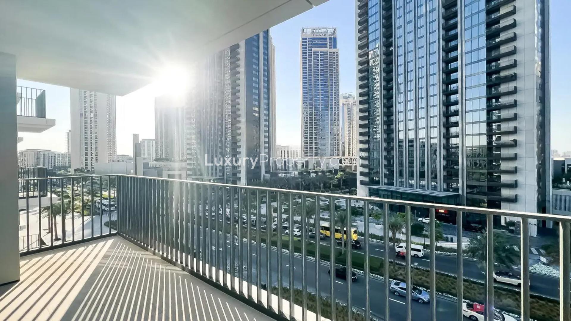 Empty bedroom in Palace Residences, Dubai Creek Harbour, featuring built-in wooden wardrobe