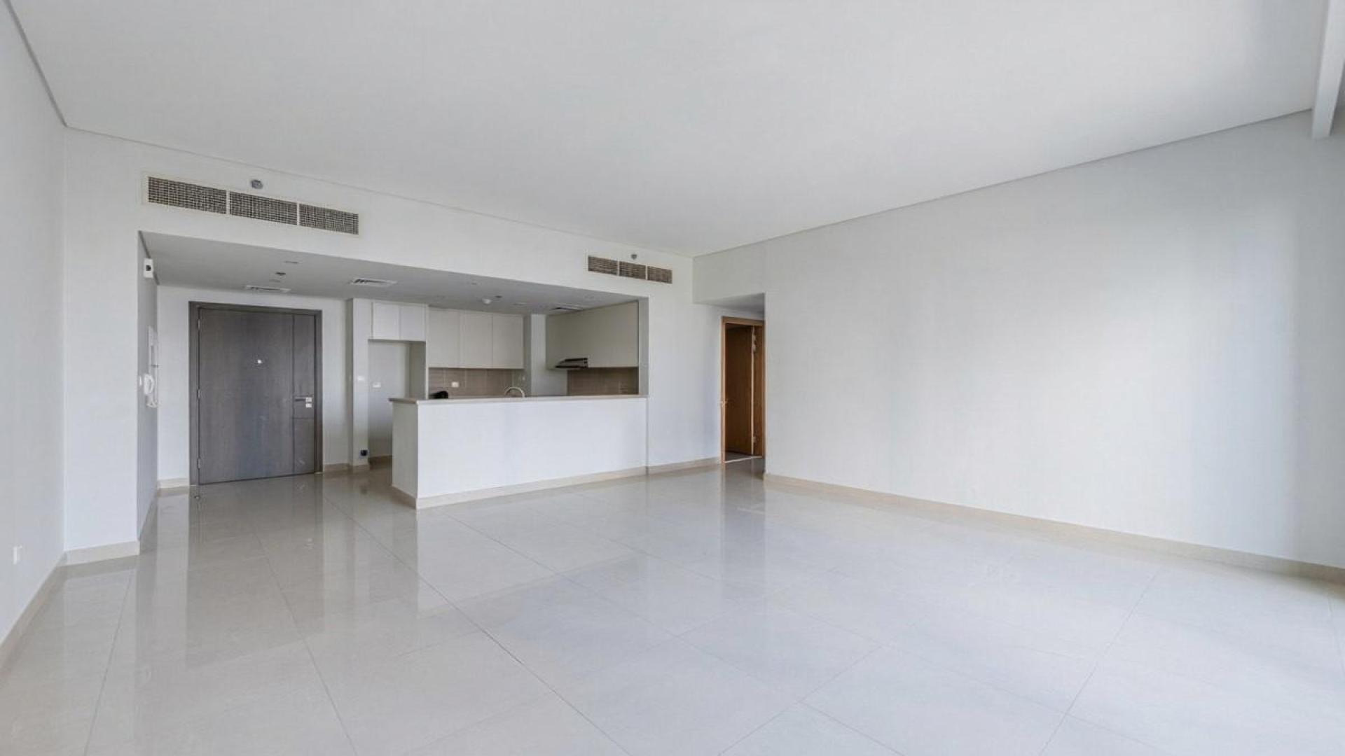Empty apartment interior with large windows and Burj Khalifa view, Dubai Creek Harbour