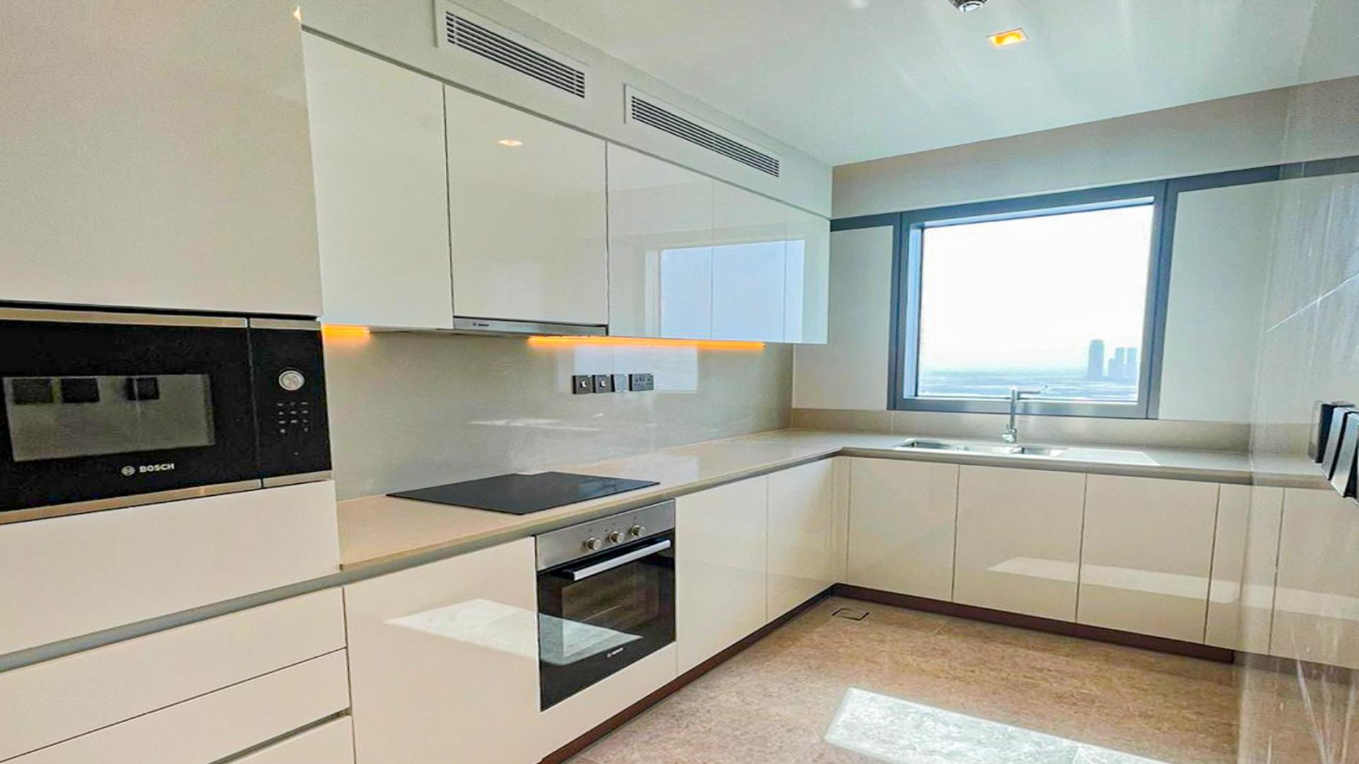 "Spacious furnished dining area with sea view in Dubai Creek Harbour apartment for sale.",Modern kitchen with sea view in fully furnished 2-bedroom apartment, Dubai Creek Harbour