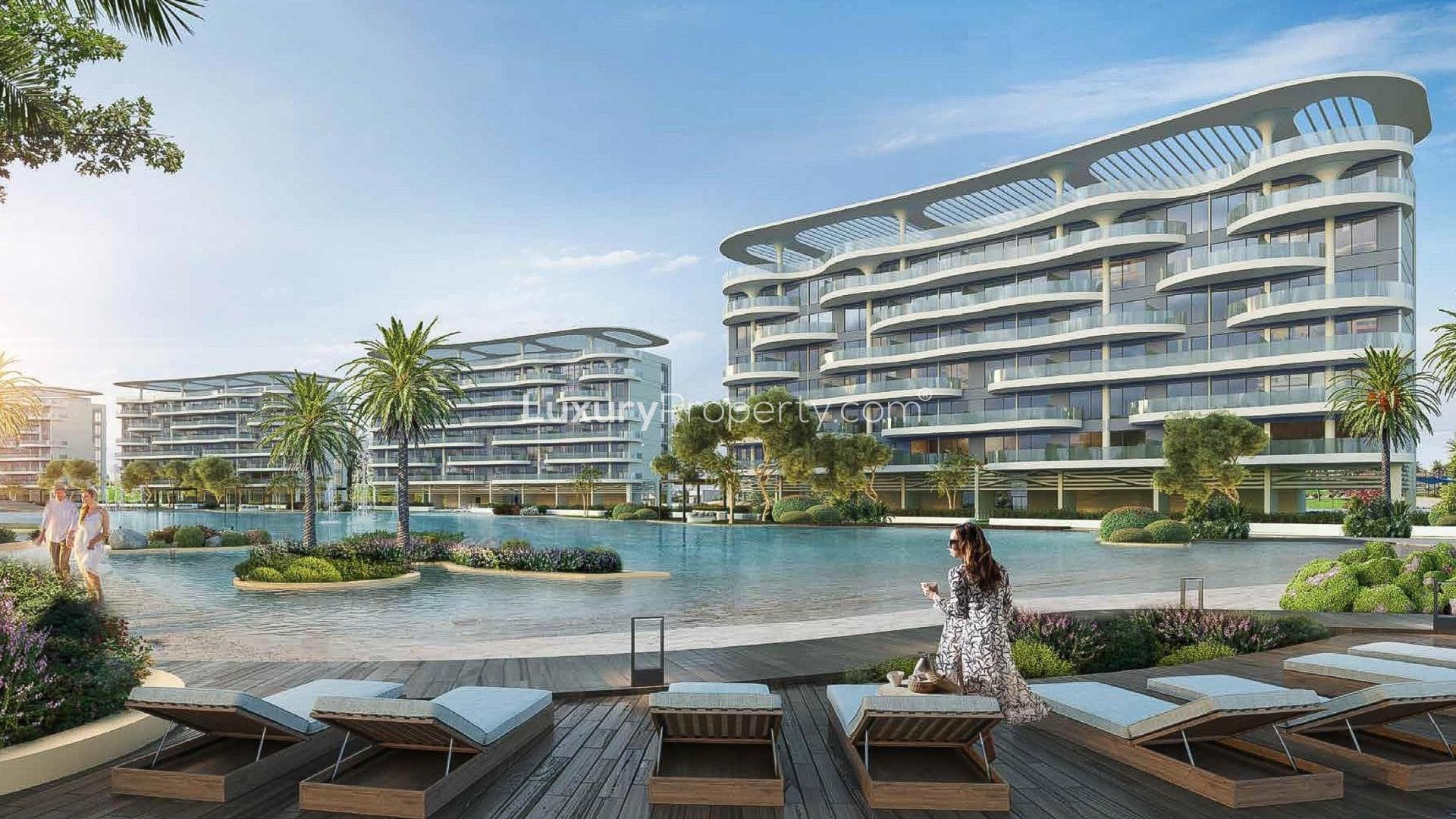 Luxury apartment buildings overlooking serene lagoon at Damac Lagoons, perfect for sale