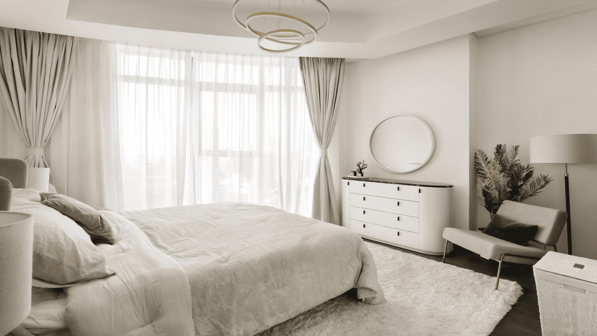 "Spacious balcony in Downtown Dubai apartment with city skyline views, stylish seating, and greenery.",Beautifully furnished bedroom in Downtown Dubai apartment, featuring elegant decor and natural light