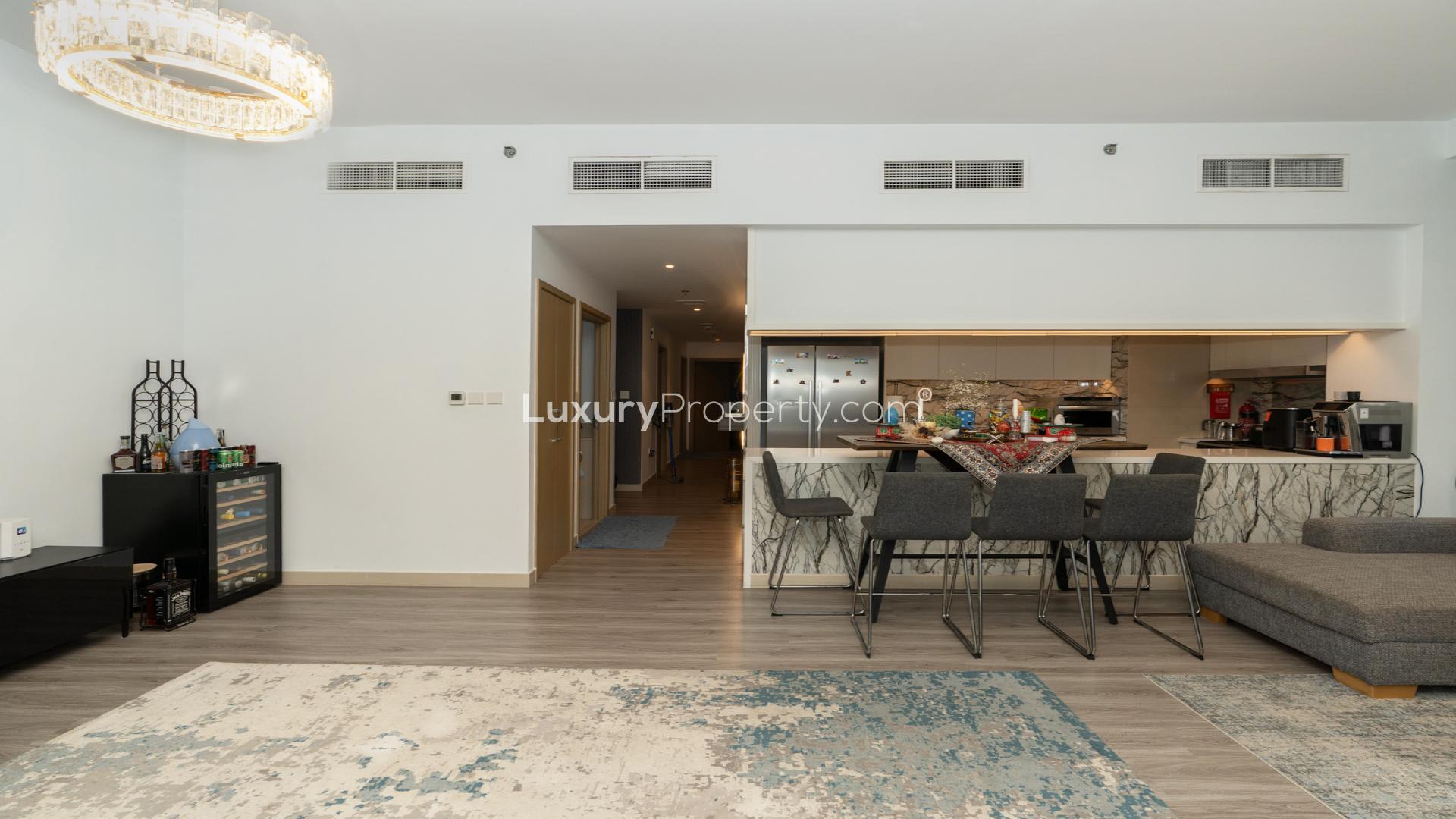Modern living room with open kitchen in Creek Palace apartment, Dubai Creek Harbour