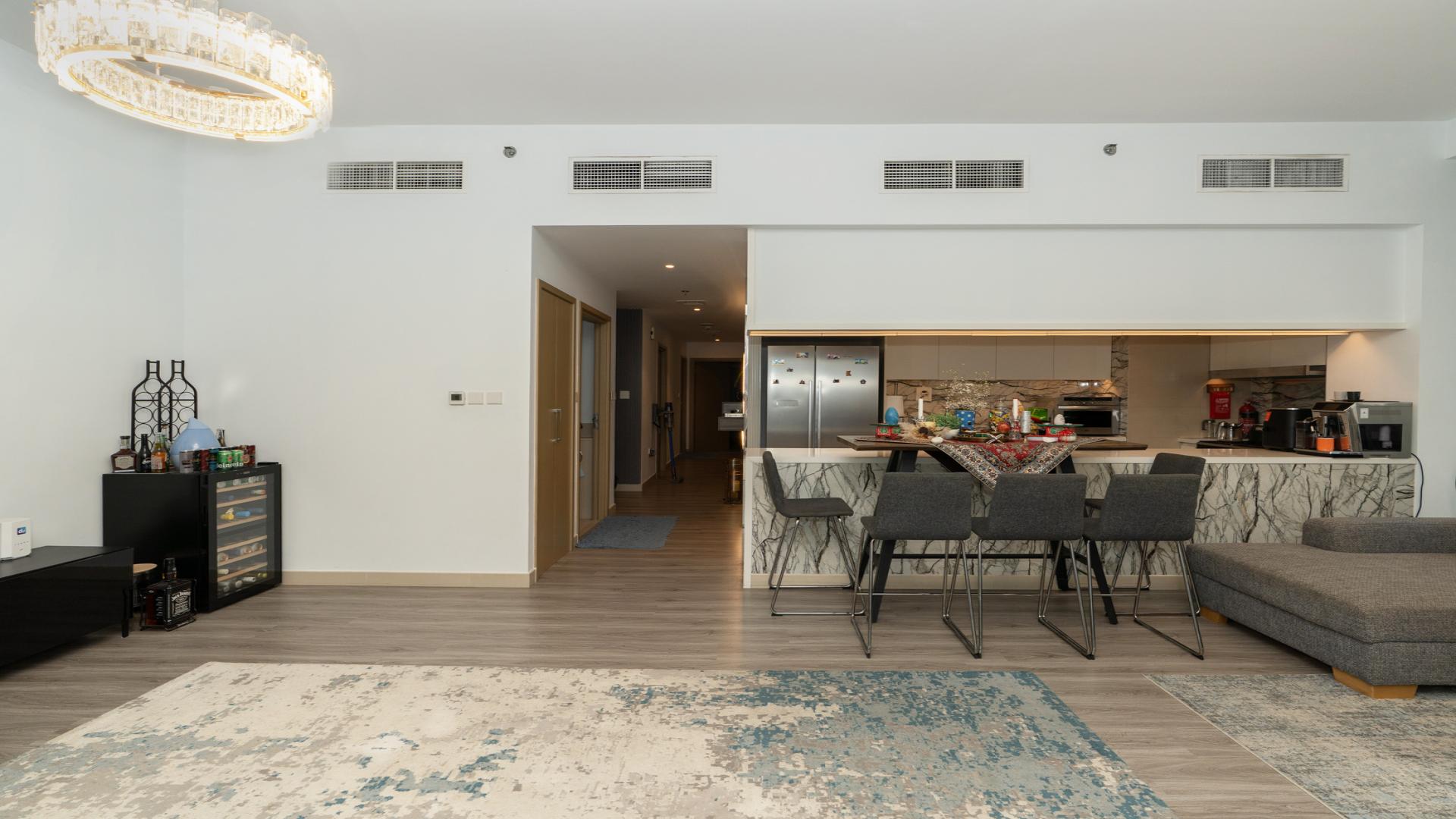 Modern living room with open kitchen in Creek Palace apartment, Dubai Creek Harbour