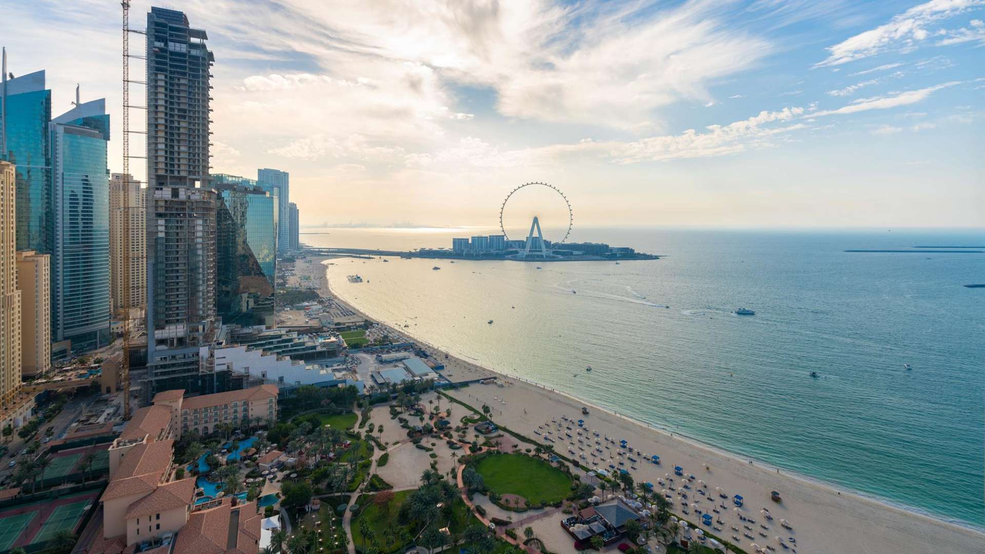 Aerial view of Jumeirah Beach Residence skyline and beach in Dubai, featuring Ain Dubai