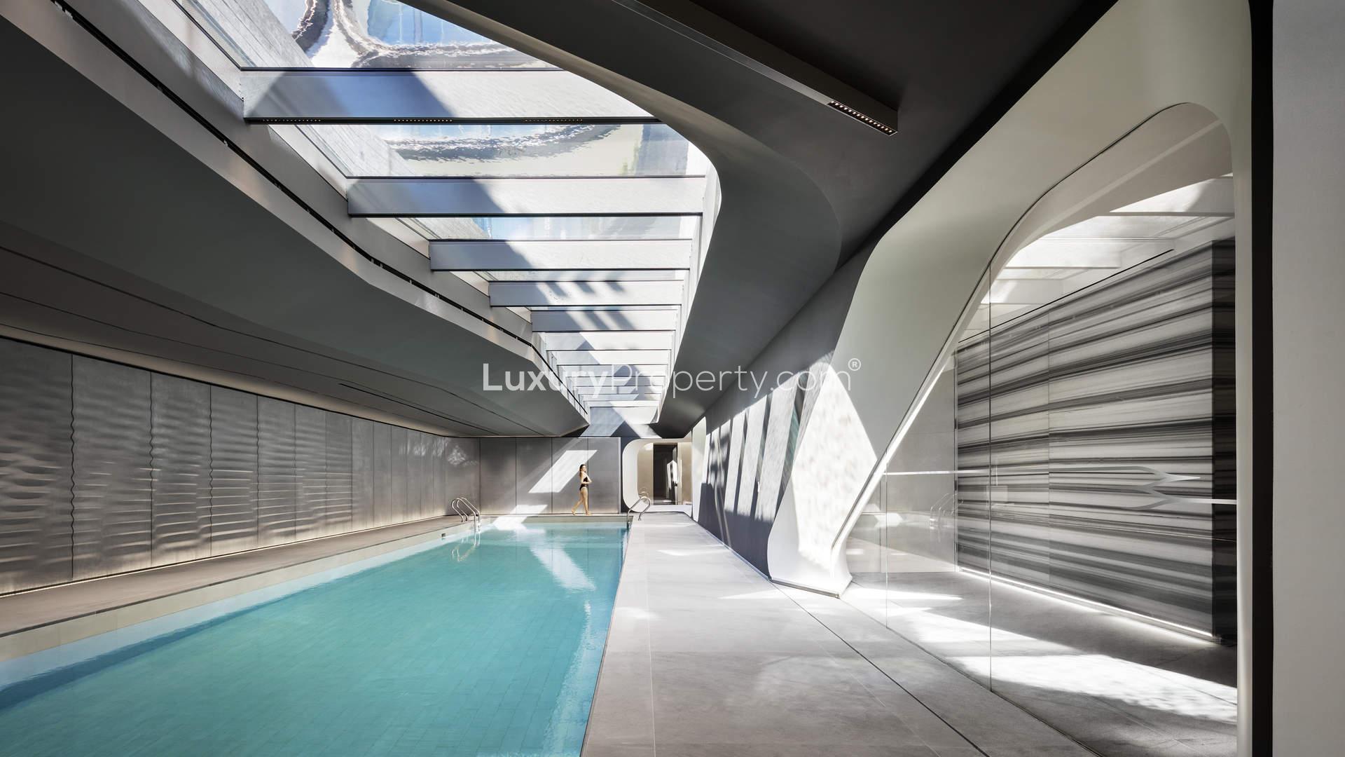 Modern architectural apartment building in West Chelsea, New York, surrounded by lush greenery