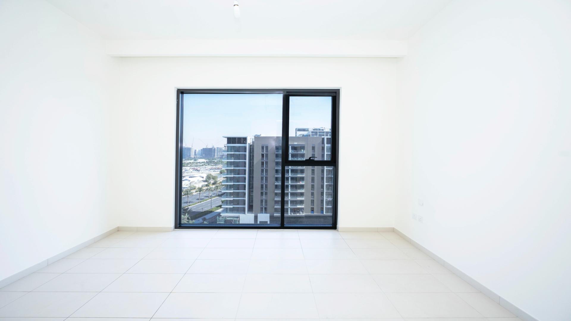 Bright open-plan kitchen and living area in 2-bedroom Dubai Hills apartment for sale