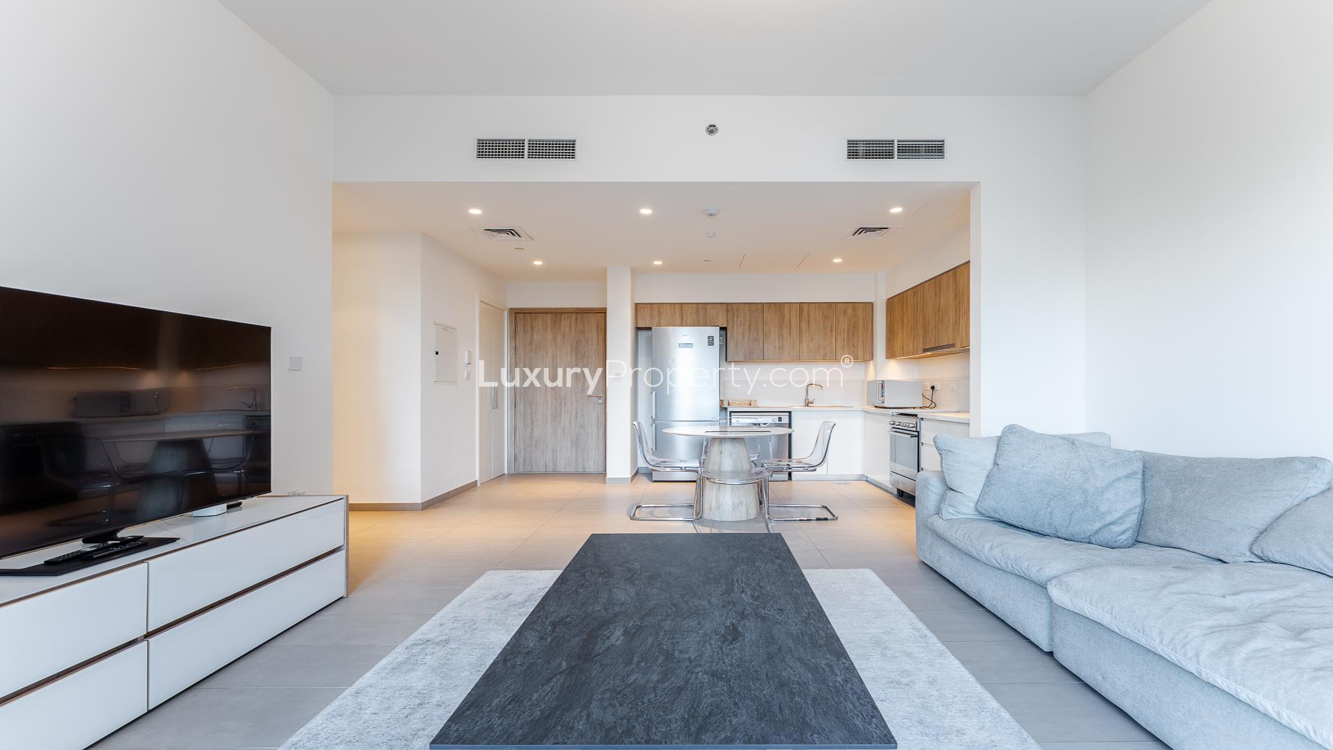 Modern living room in two-bed apartment, Park Ridge, Dubai Hills Estate, open kitchen layout