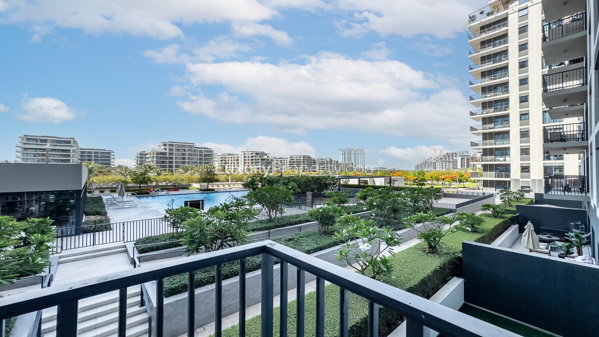 Modern living room and kitchen in Dubai Hills Estate apartment, Park Ridge, with balcony view