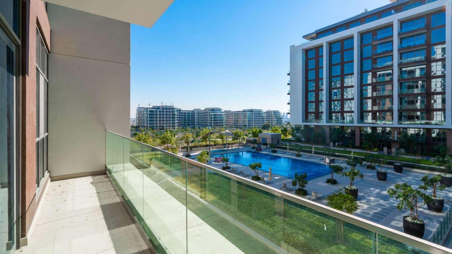 Modern living room in Dubai Hills Estate apartment with large windows and natural light