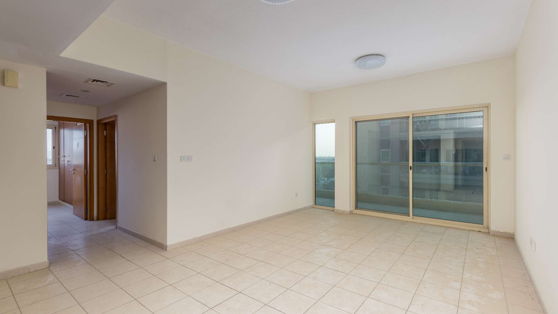 Hallway in Al Alka apartment with wooden doors and natural light