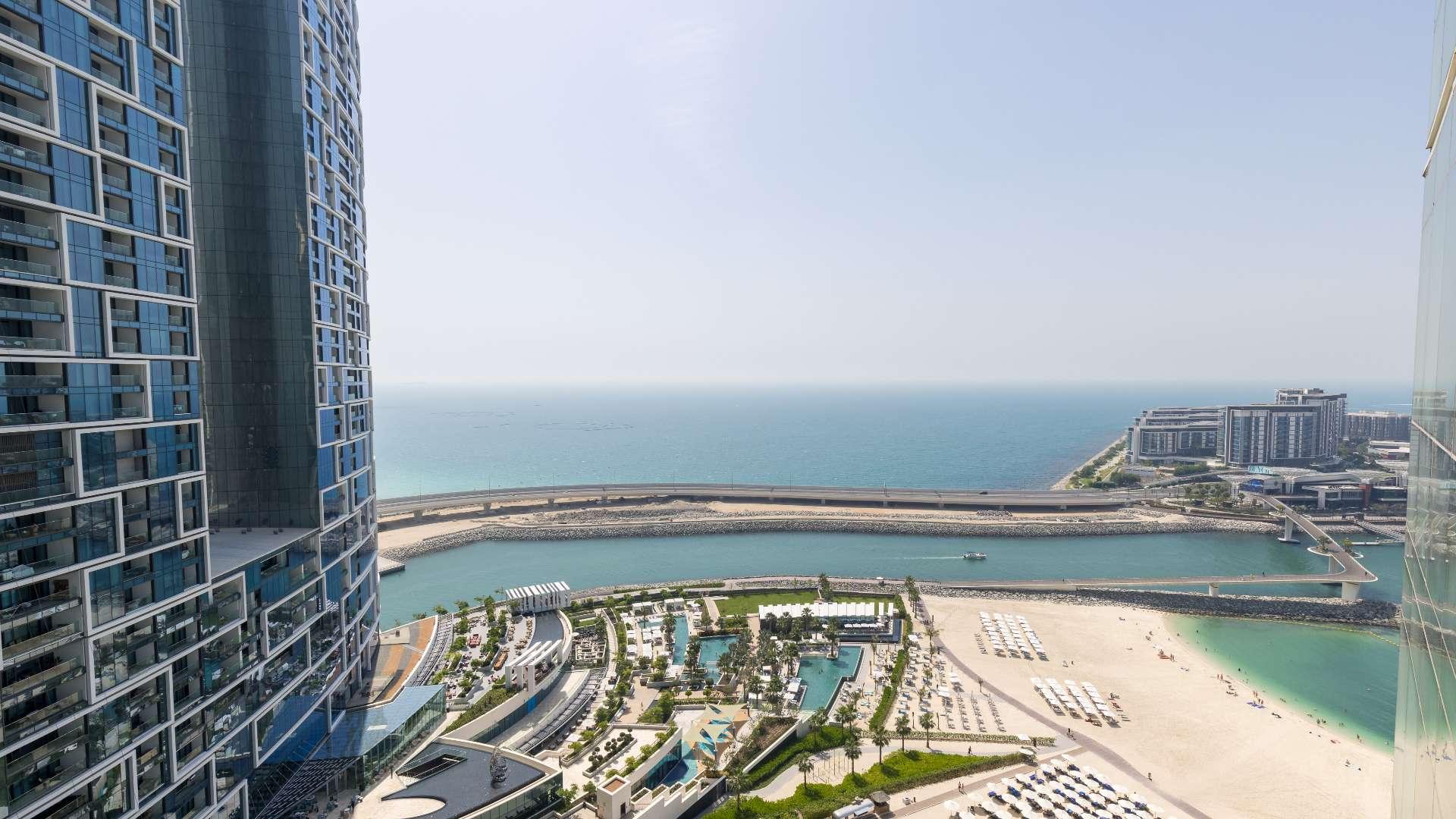 Living room in Al Bateen Residences apartment, Jumeirah Beach Residence, with modern decor and TV