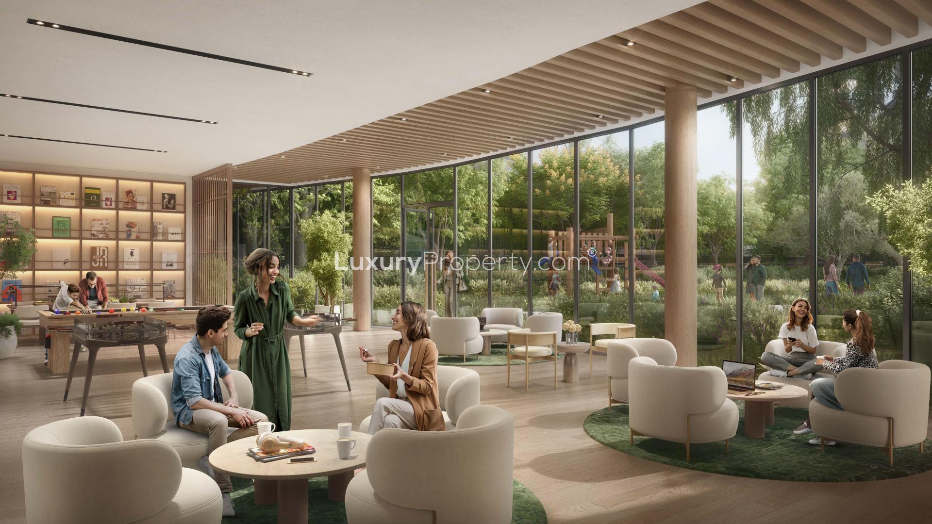 "Spacious living area with modern kitchen in Dubai Land's Ghaf Woods apartment for sale.",Modern lounge in Cilia, Ghaf Woods apartment with lush garden views, Dubai Land