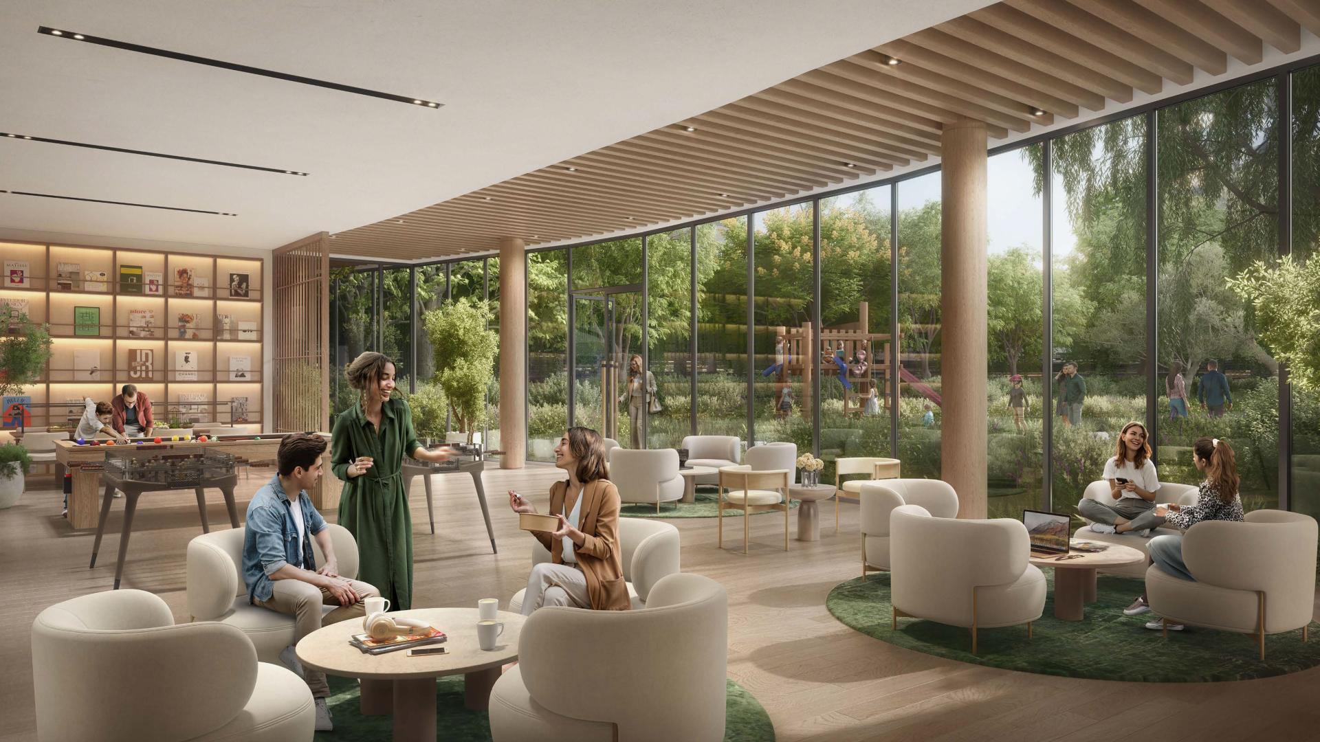 "Spacious living area with modern kitchen in Dubai Land's Ghaf Woods apartment for sale.",Modern lounge in Cilia, Ghaf Woods apartment with lush garden views, Dubai Land