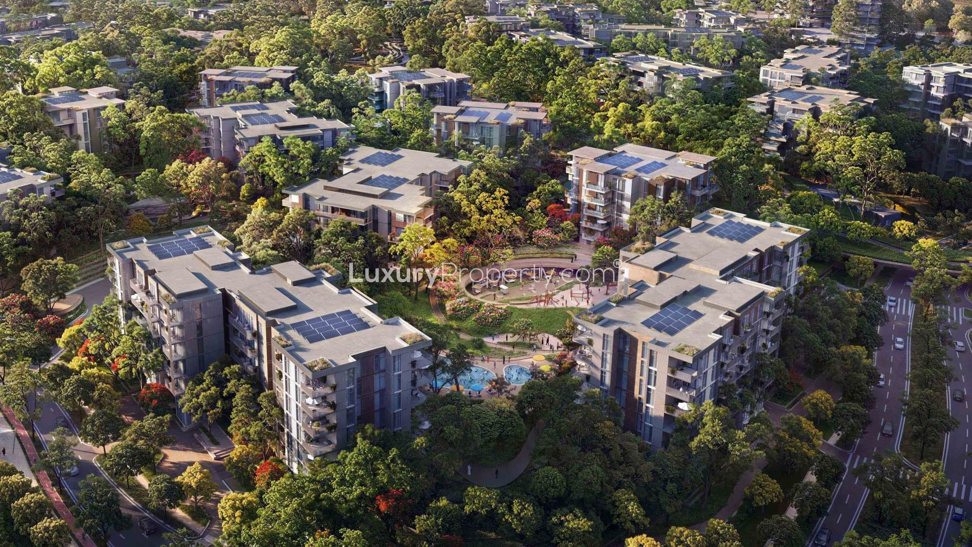 "Spacious living room and balcony view at Lacina Residences, Ghafwoods, Dubai Land apartment.",Aerial view of Lacina Residences in Ghafwoods, Dubai Land, surrounded by lush greenery