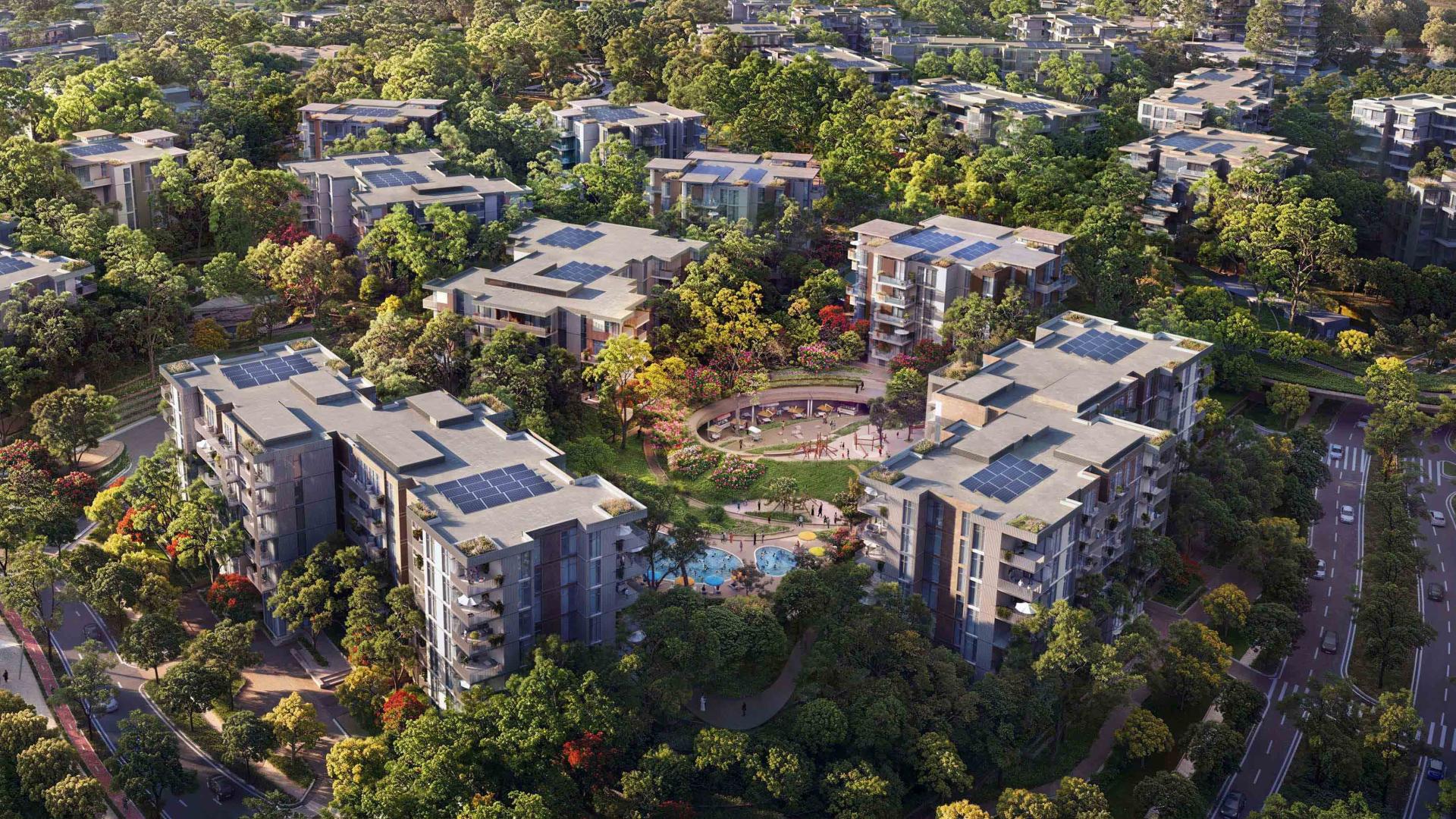 "Spacious living room and balcony view at Lacina Residences, Ghafwoods, Dubai Land apartment.",Aerial view of Lacina Residences in Ghafwoods, Dubai Land, surrounded by lush greenery