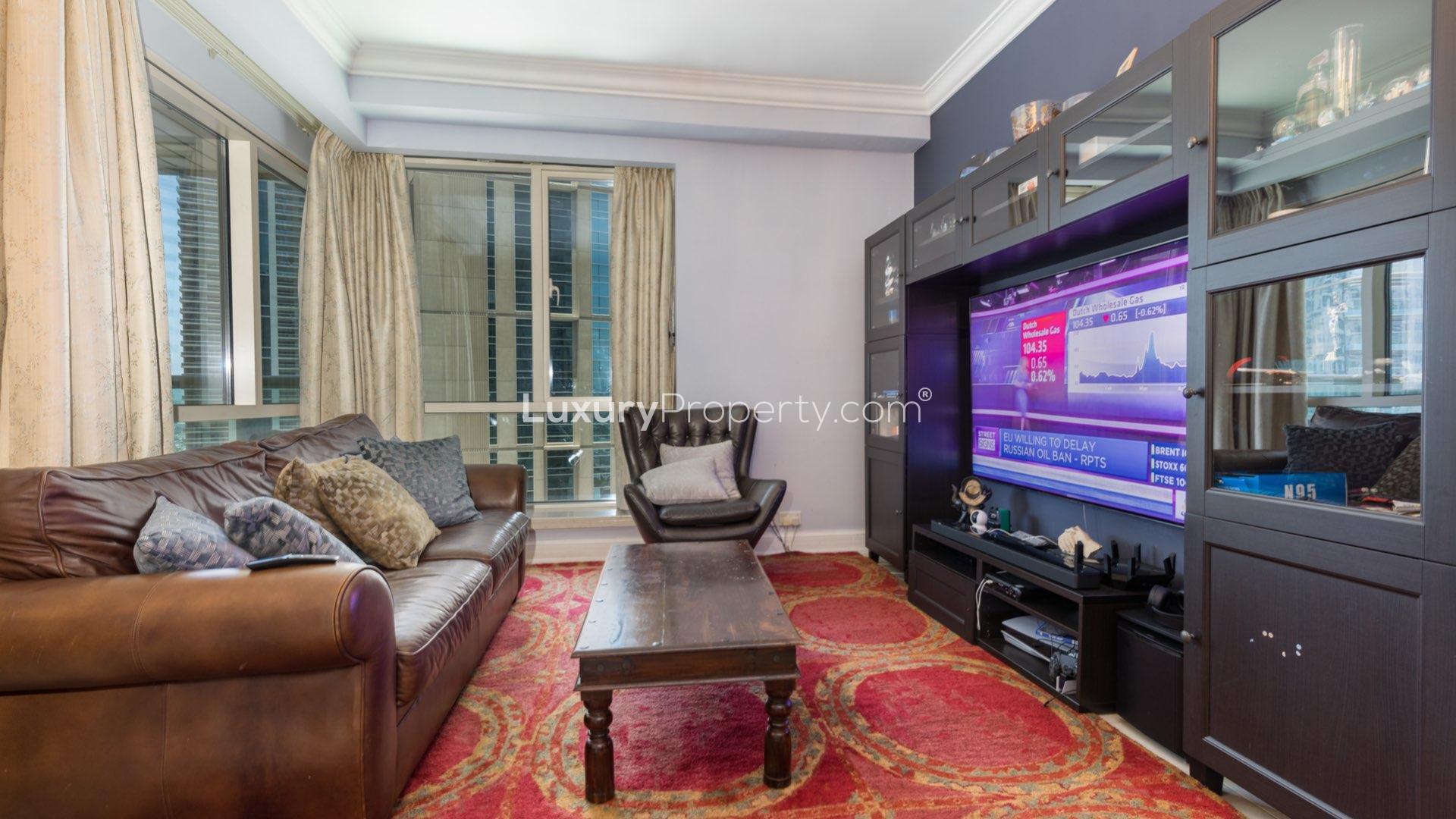 Luxurious living room in Dubai Marina apartment, featuring modern decor and entertainment center