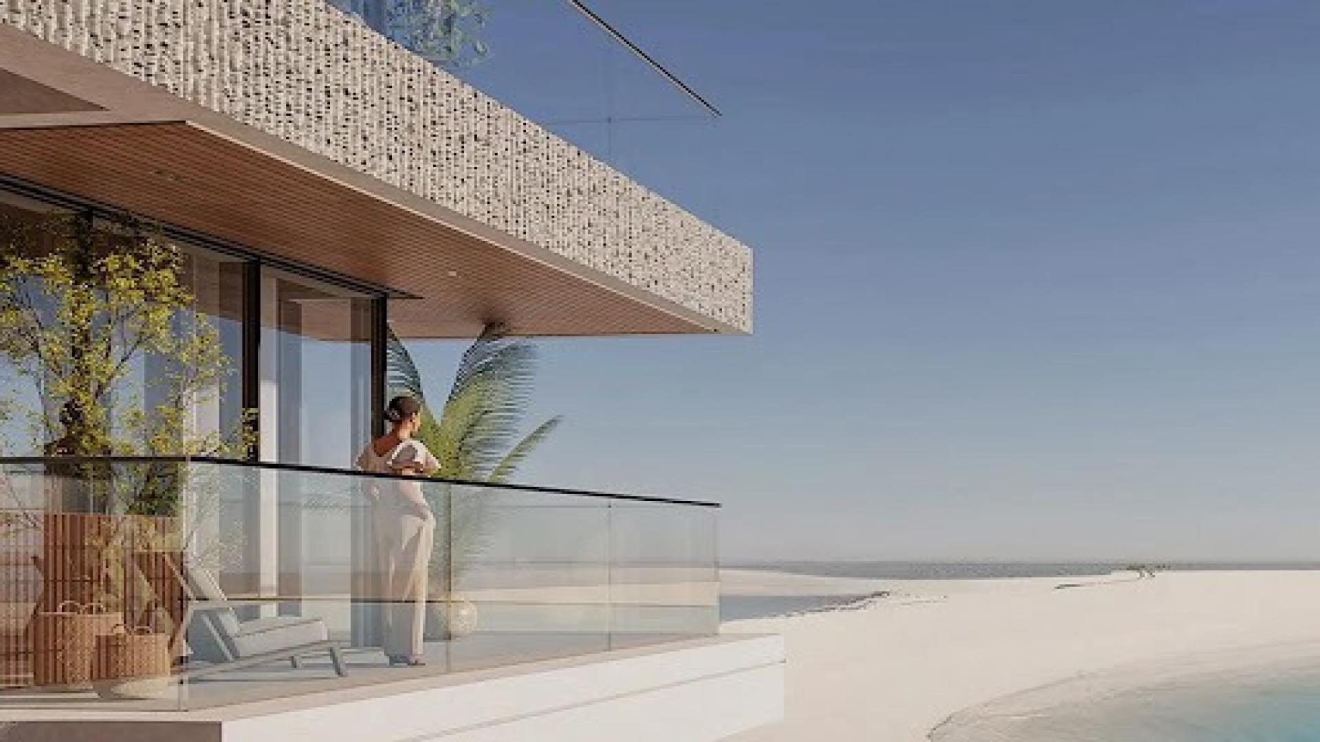 "Modern Ellington Cove apartment with ocean view, Dubai Islands sunset, luxury living.",2-bedroom apartment balcony view in Ellington Cove, Dubai Islands, overlooking beach and ocean