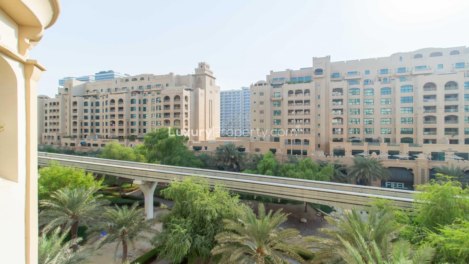 Spacious balcony view of Shoreline Apartment in Palm Jumeirah with outdoor seating and plants