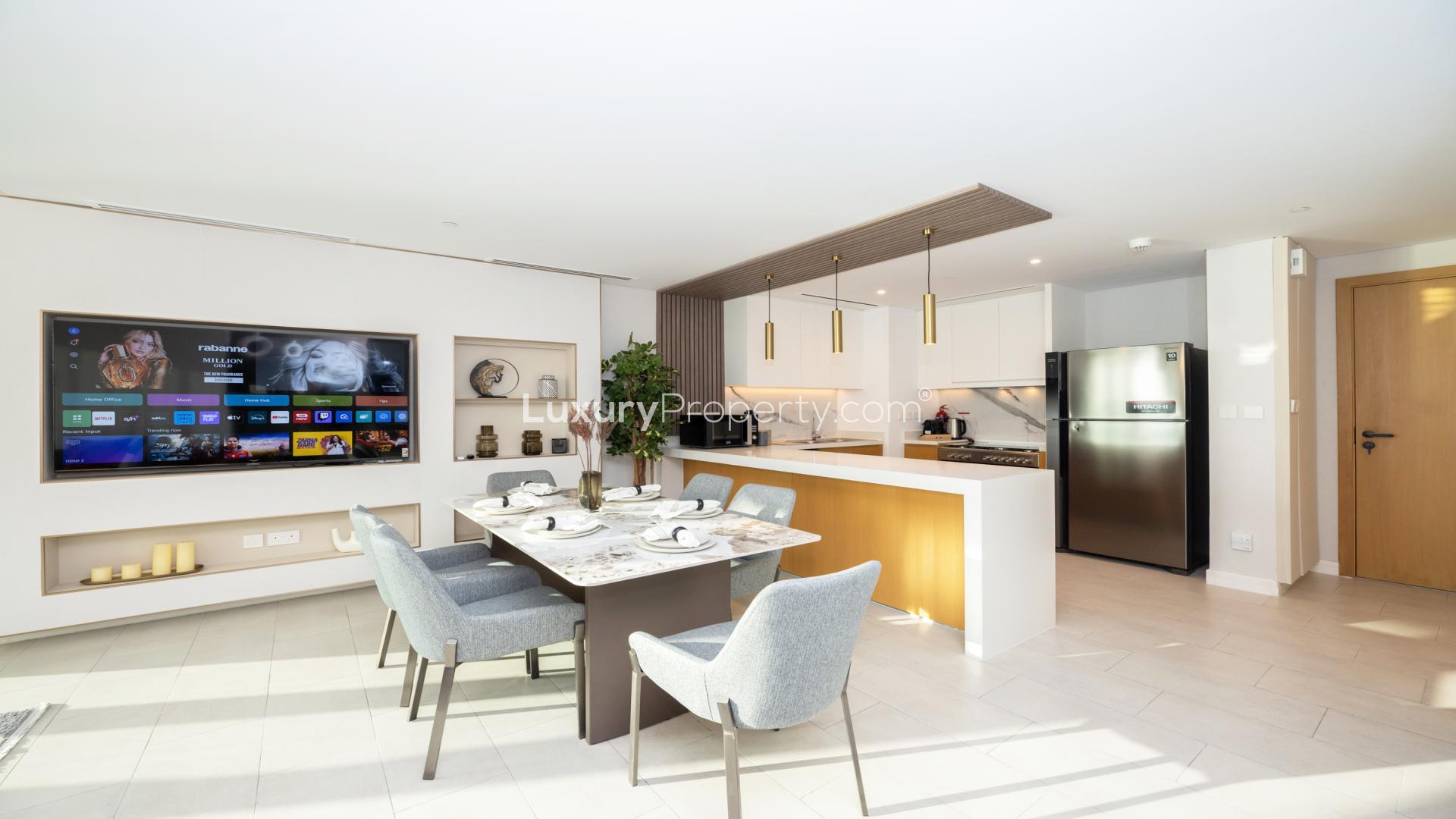 Sunset view from La Vie apartment balcony overlooking Jumeirah Beach Residence and Ferris wheel