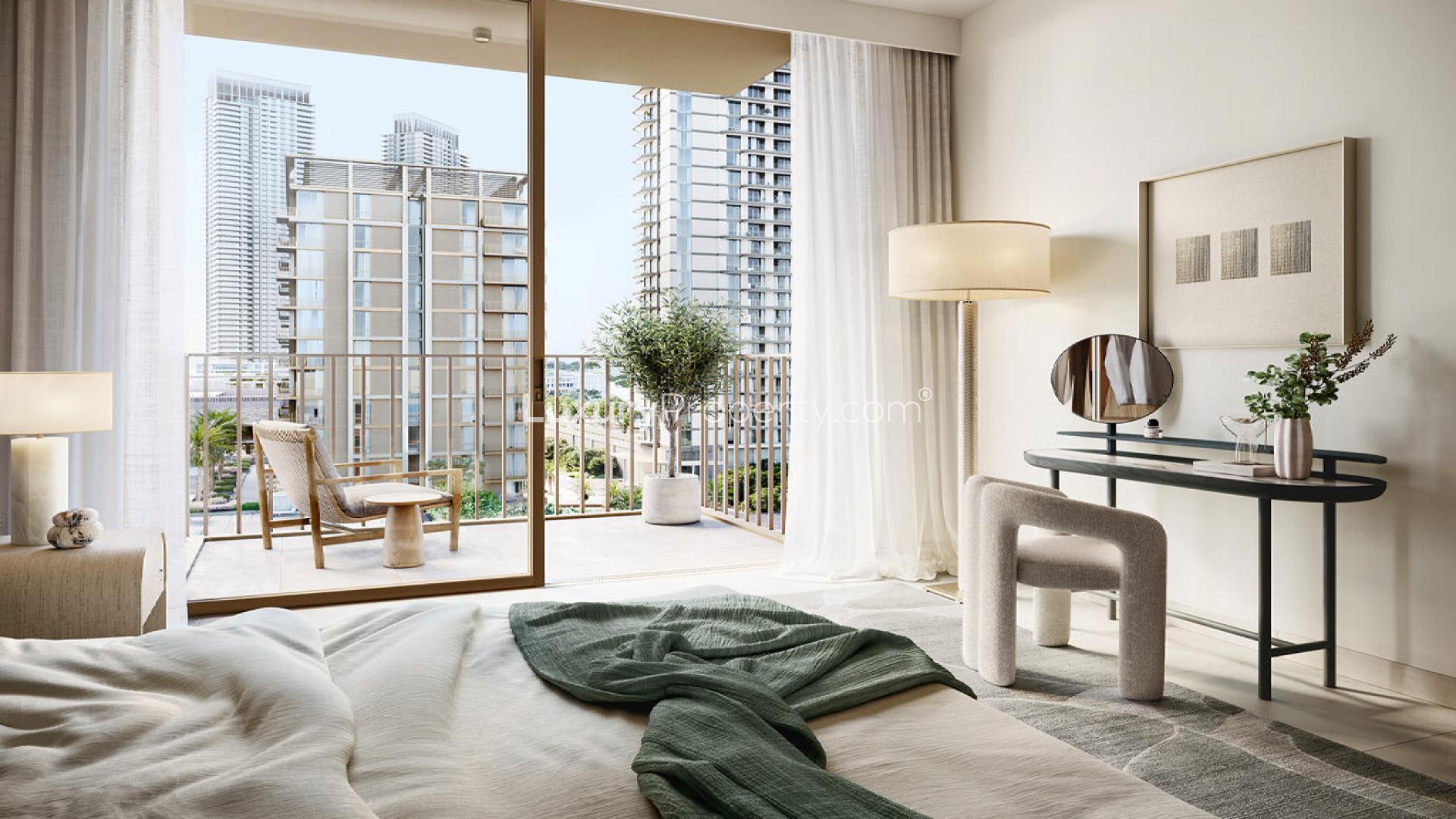 "Luxury waterfront apartments at Oria Creek Beach, Dubai Creek Harbour skyline view at dusk.",Luxurious bedroom with balcony view at Oria Creek Beach, Dubai Creek Harbour apartment