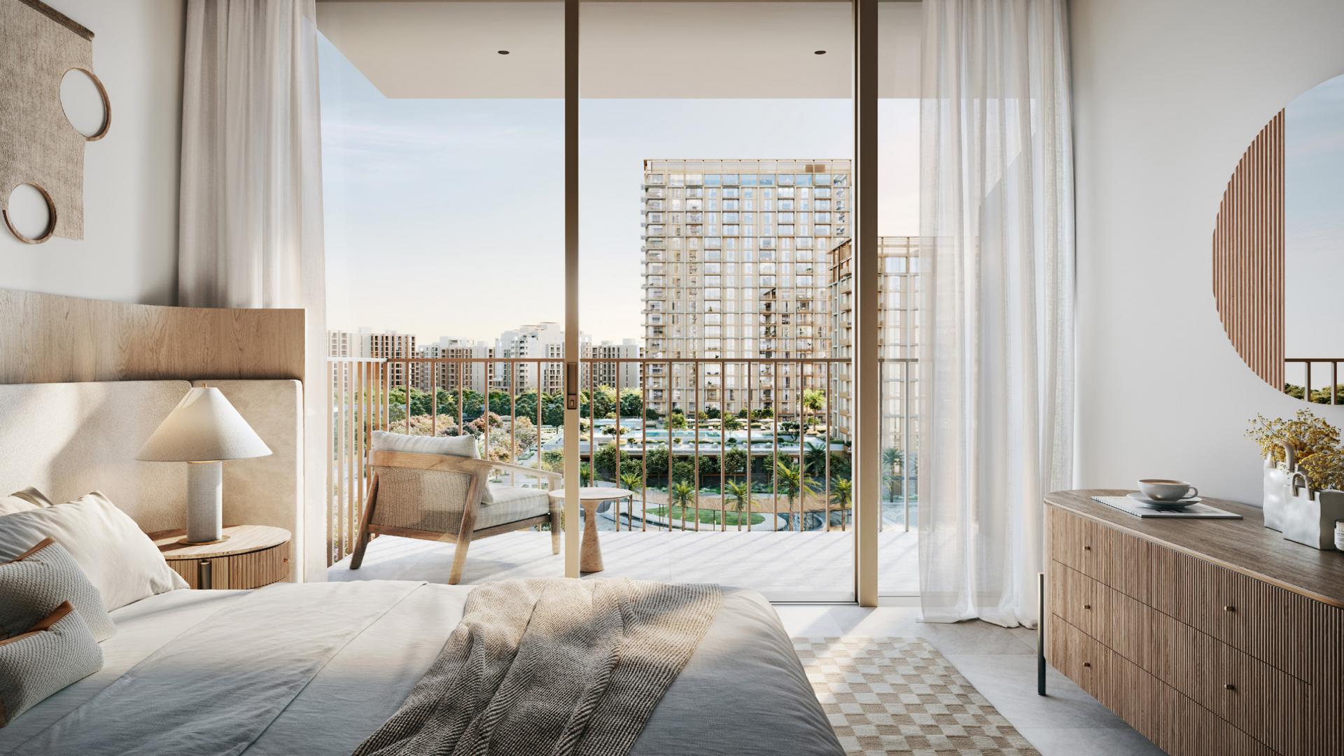 Modern apartments in Dubai Creek Harbour's Creek Beach community, surrounded by palm trees and walkways