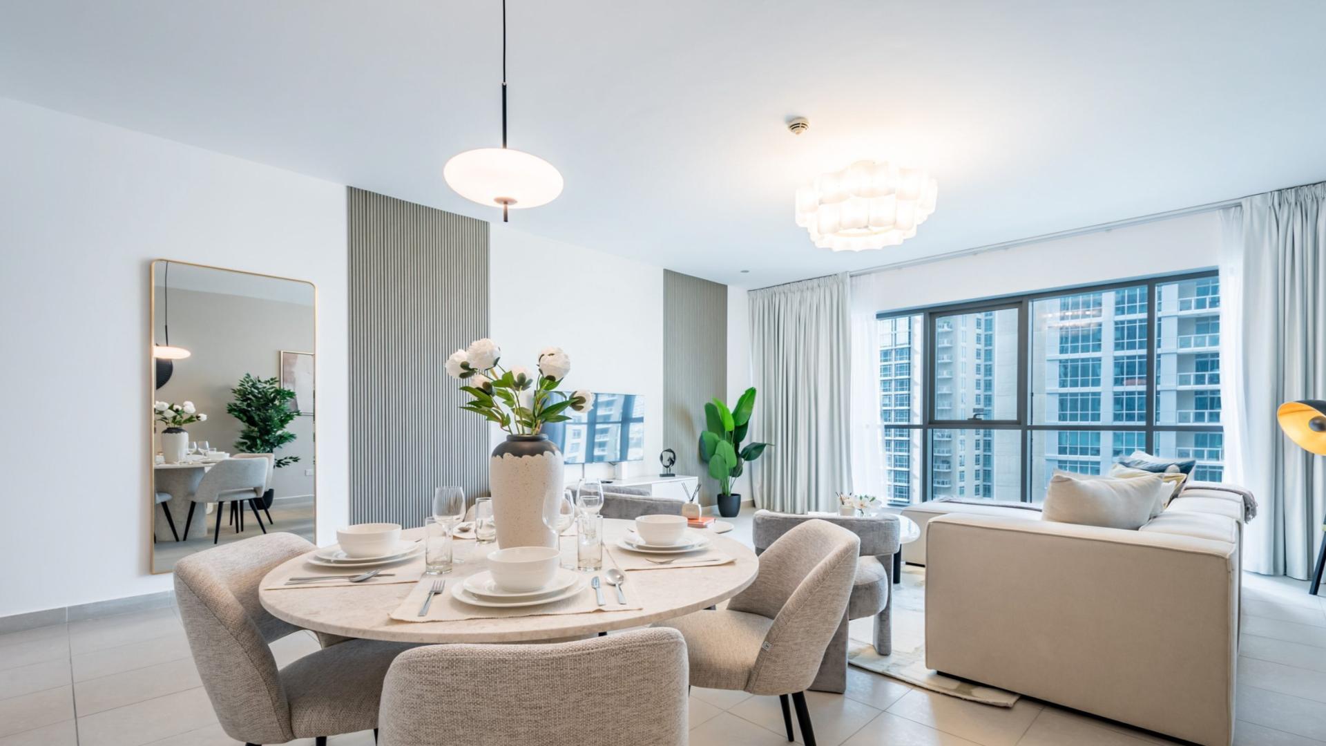 "Balcony with cityscape view from 2-bedroom apartment in Boulevard Central Towers, Downtown Dubai.",Furnished living and dining area in 2-bedroom apartment, Downtown Dubai with Dubai Fountain view