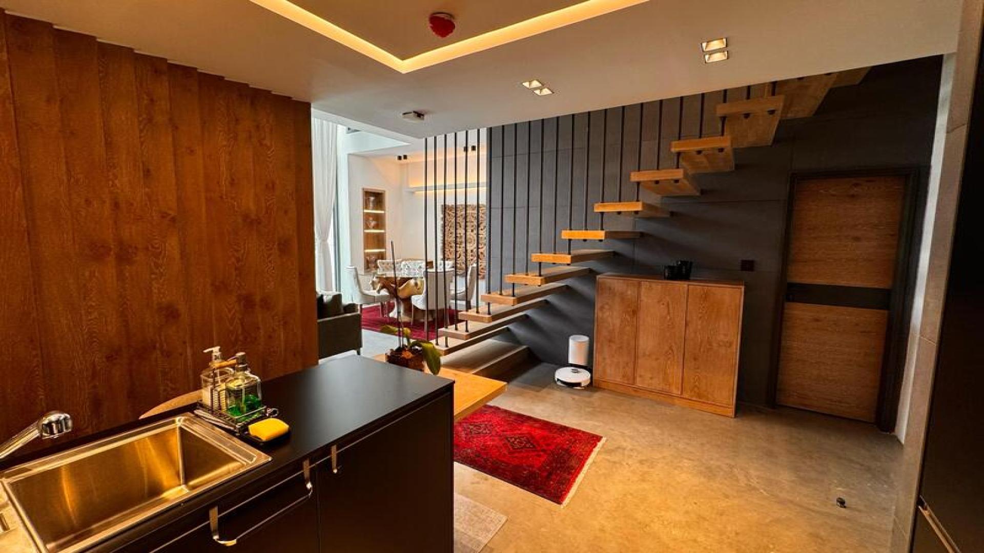 Modern kitchen and staircase in Sobha Hartland apartment, Mohammed Bin Rashid City, for sale