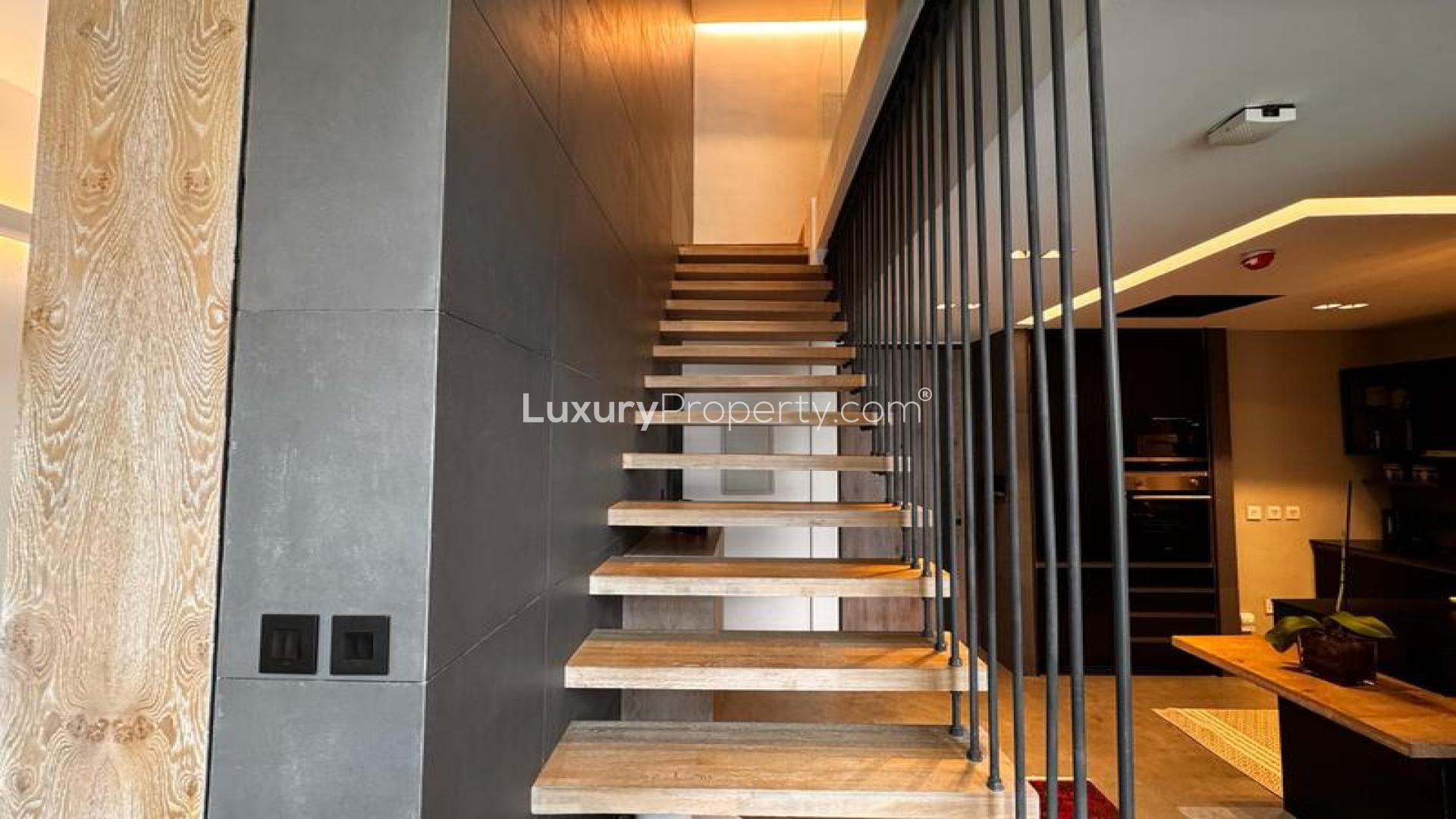 N/A,Modern living room with wooden staircase in Sobha Hartland apartment, Mohammed Bin Rashid City