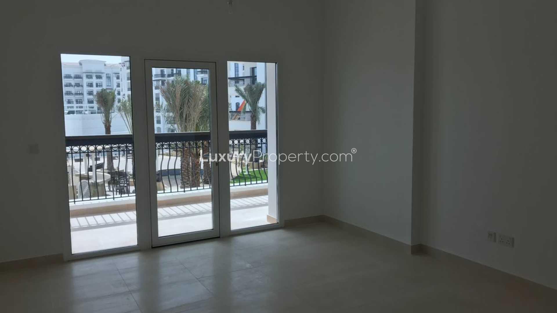 Modern kitchen with sleek countertops in Ansam apartment, Yas Island, for sale