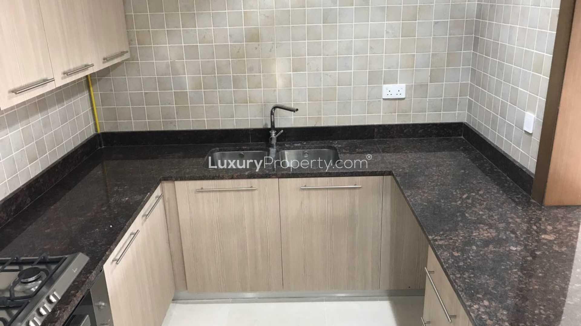 Modern kitchen view in Ansam apartment, Yas Island, with sleek cabinets and counter space