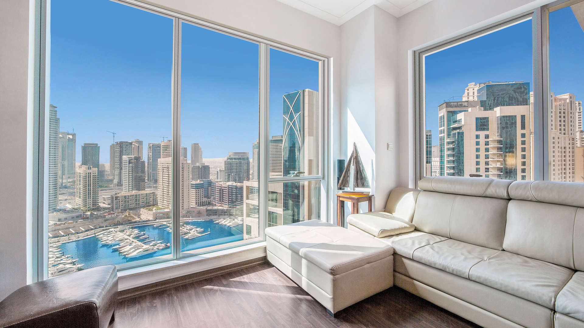 Dubai Marina waterfront view with promenade, boats, and skyscrapers near Marina Promenade apartments