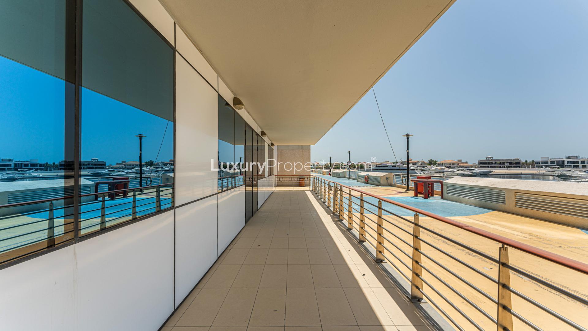 Empty living room with large windows, sea view, in Palm Jumeirah apartment for sale