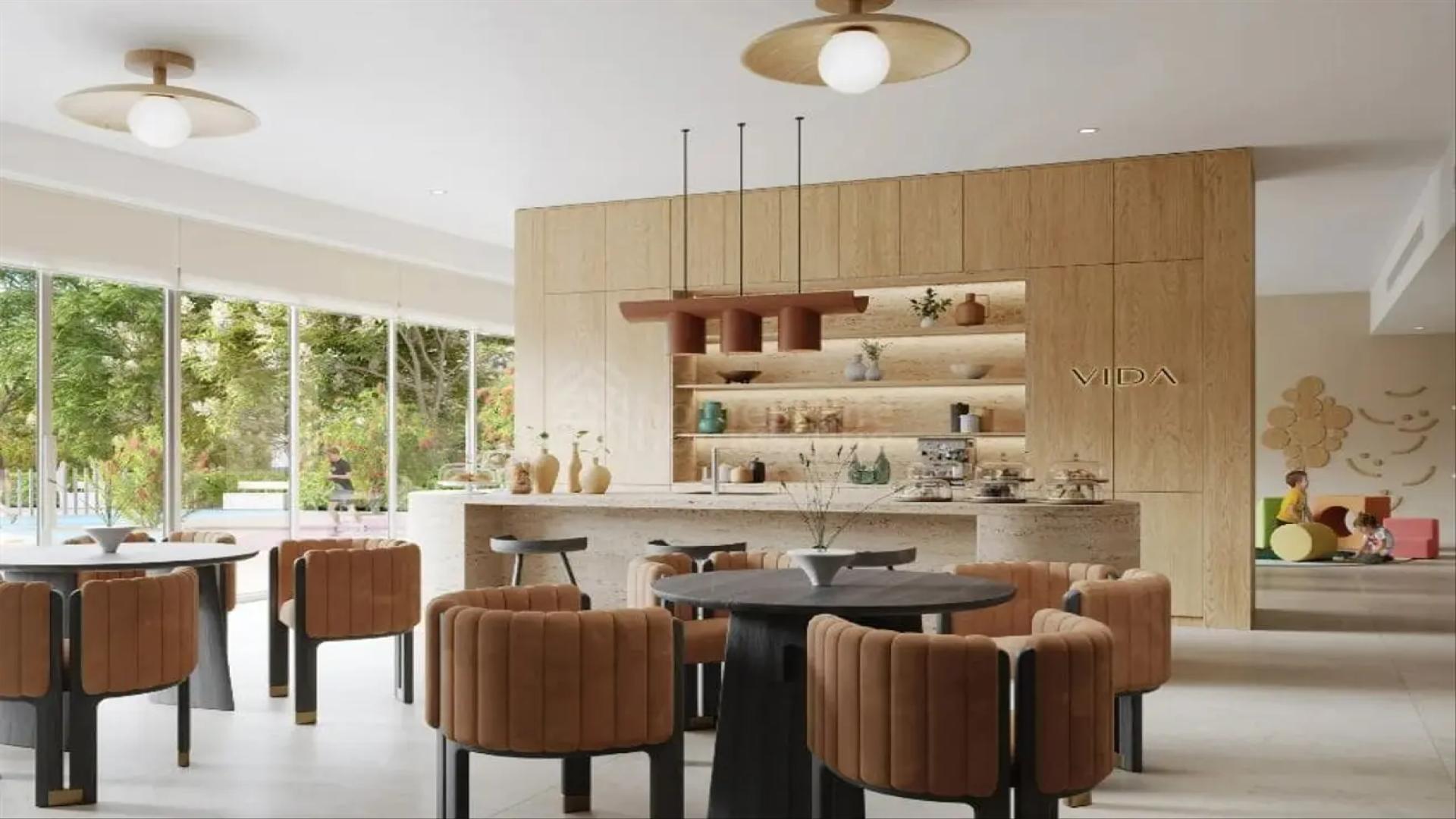 Modern dining area in Park Lane apartment, Dubai Hills Estate, with garden view