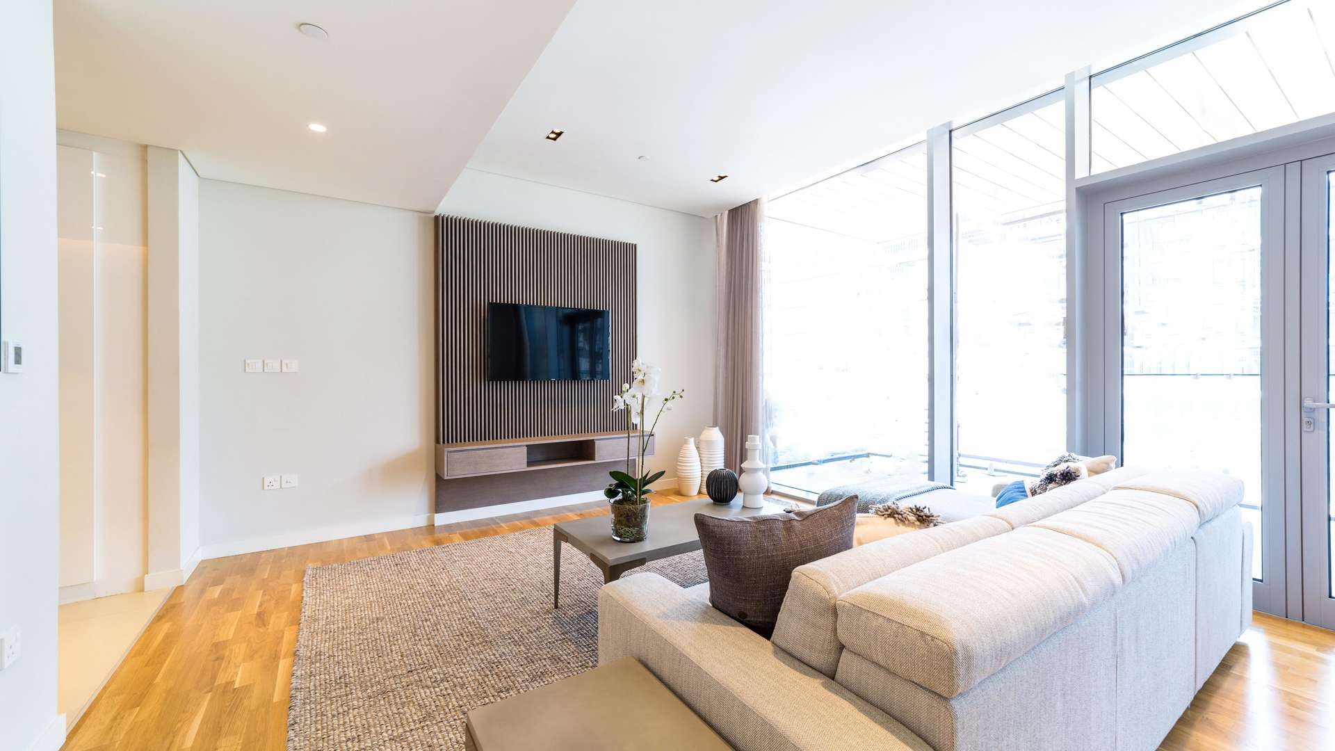 Modern living room in luxury Bluewaters apartment with large windows and stylish decor