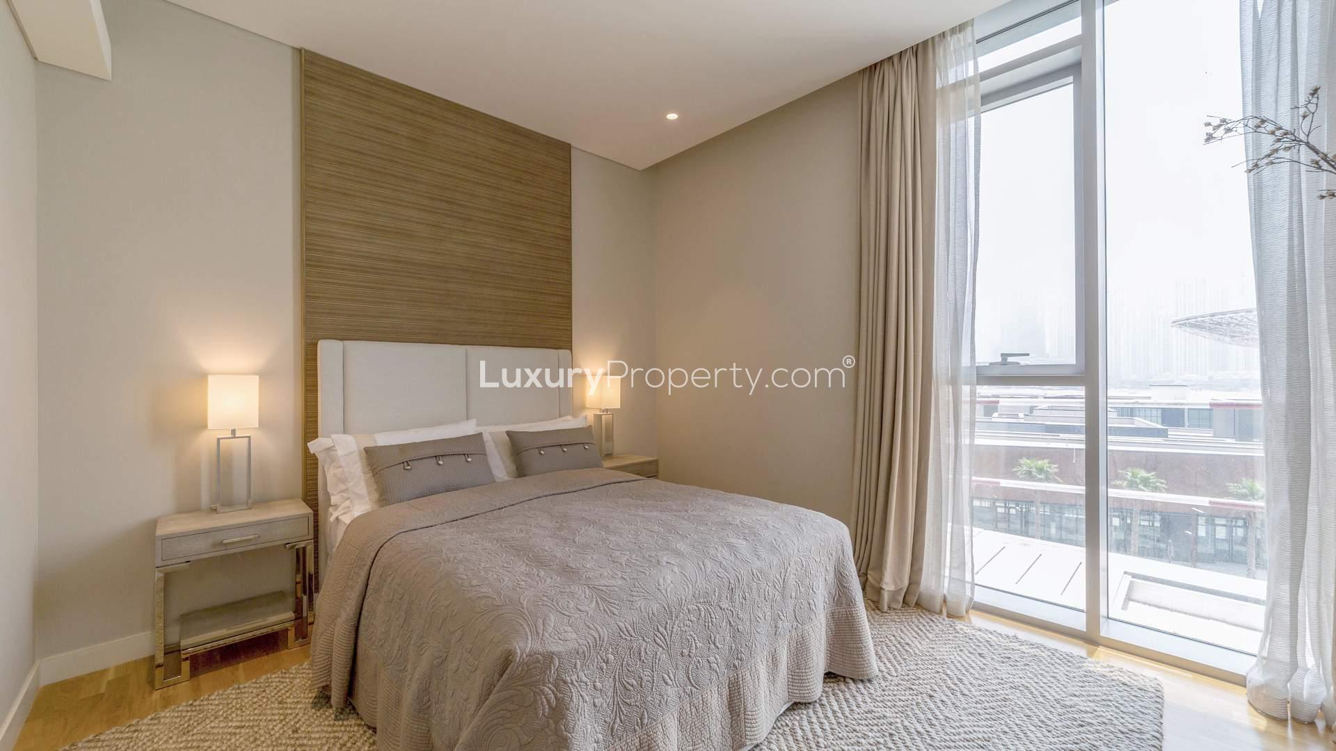 Modern bedroom in Bluewaters two-bedroom apartment, featuring elegant decor and ample natural light