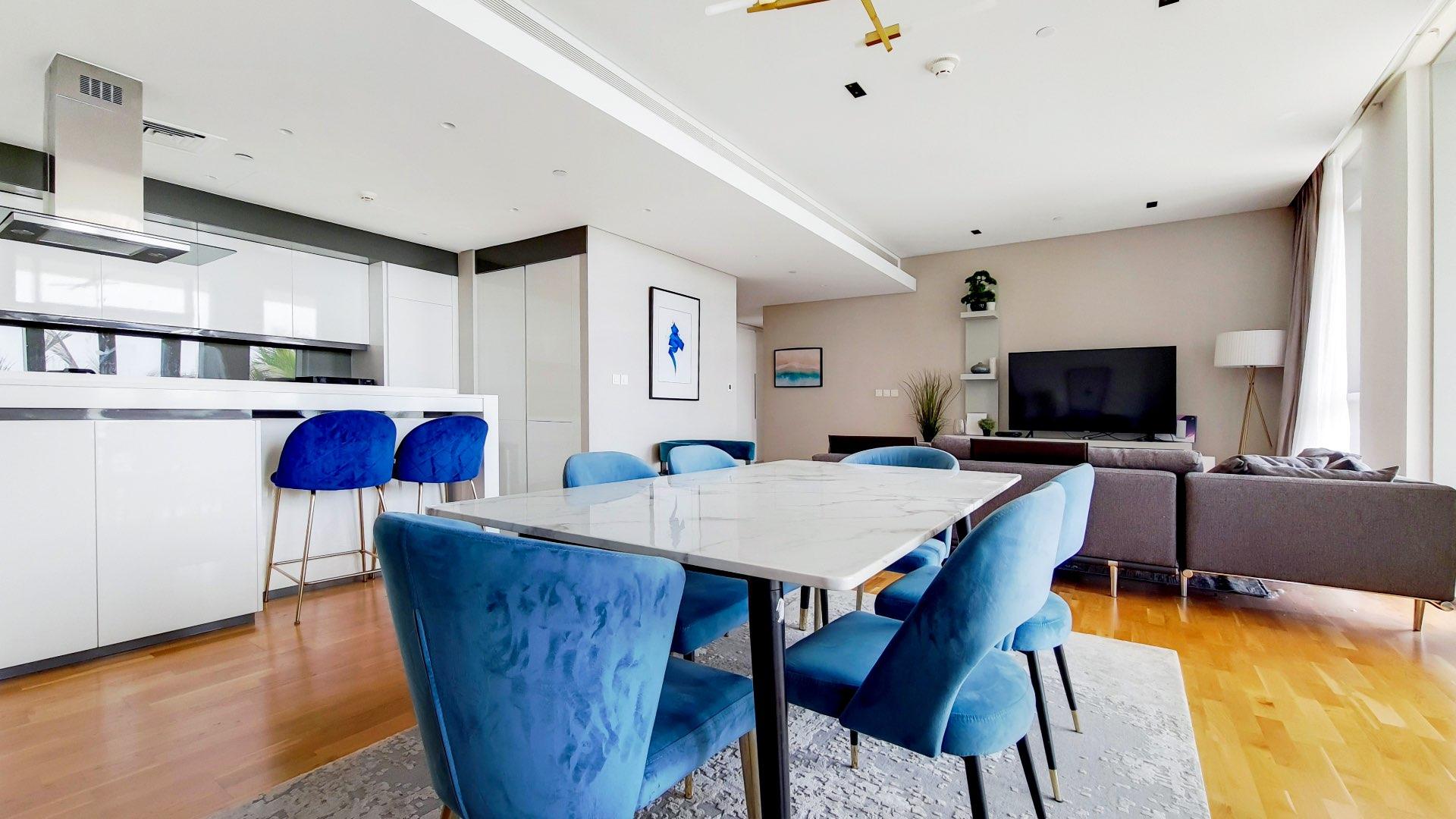 Modern living room in Bluewaters Residences apartment with stylish decor and large windows