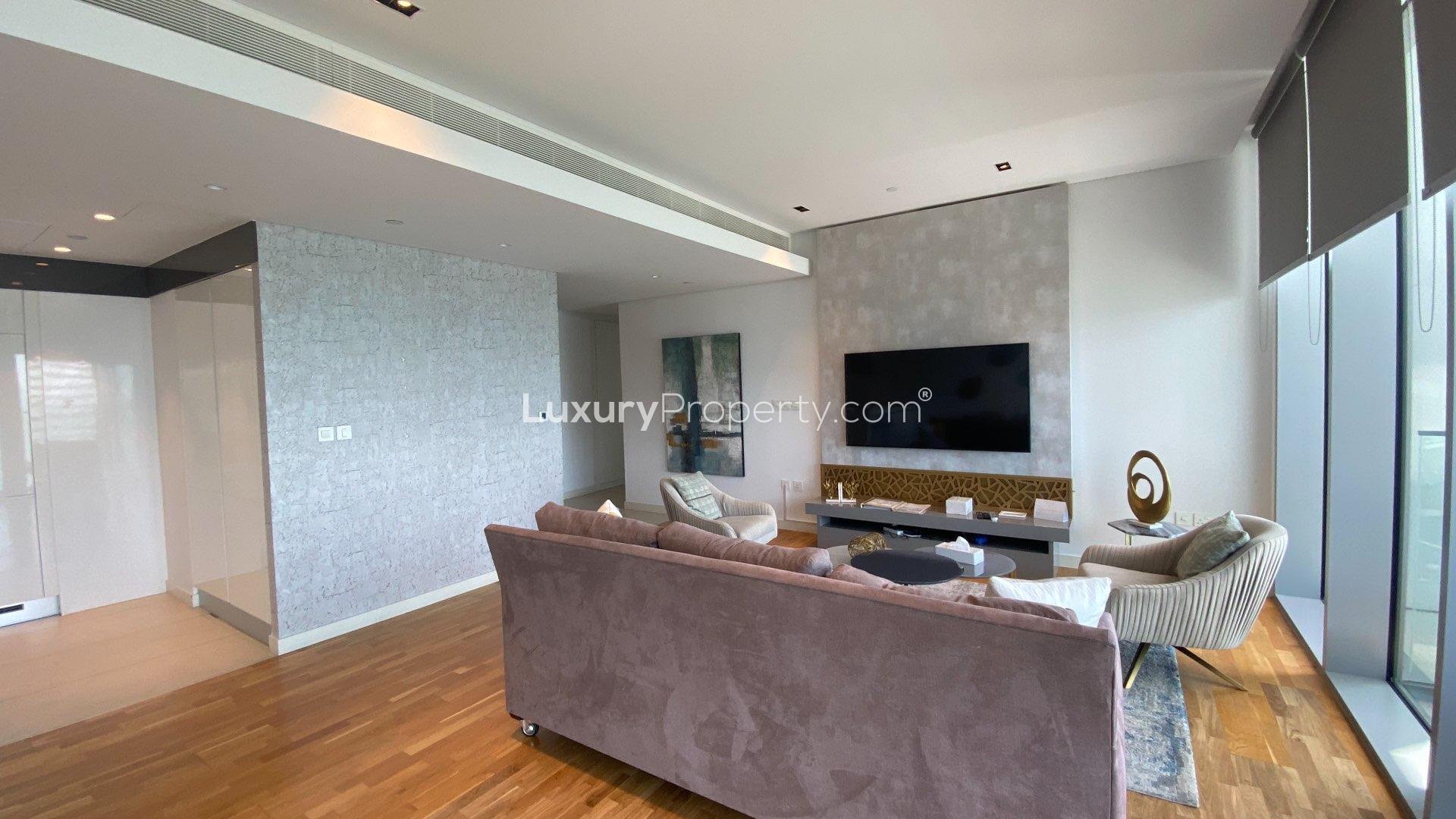 Beautiful living room in two-bedroom apartment, Bluewaters Residences, with ocean view and modern decor