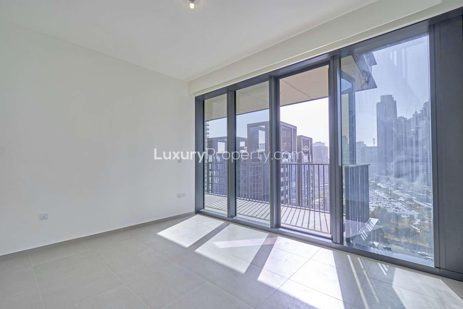 Bright living room with floor-to-ceiling windows in Downtown Dubai apartment, BLVD Heights