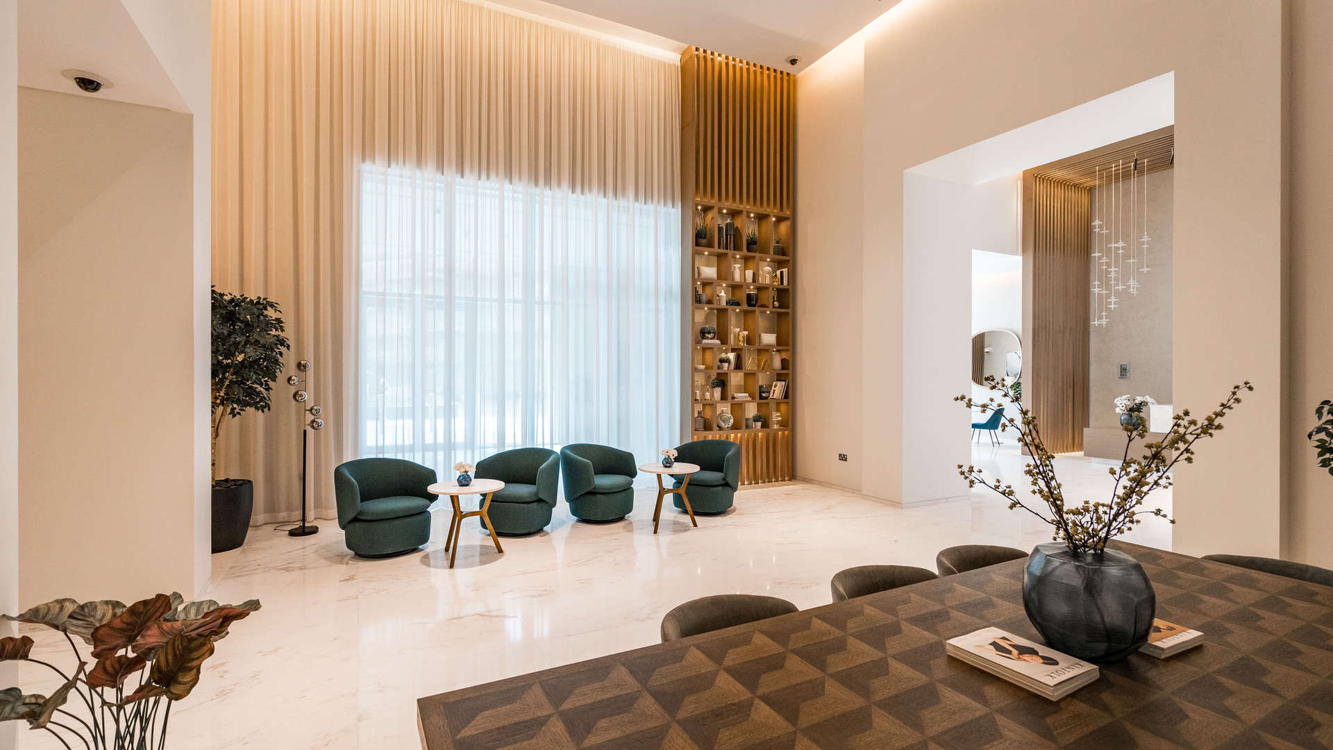 Modern lobby in Boulevard Crescent apartment, Downtown Dubai, featuring elegant marble floors and artwork