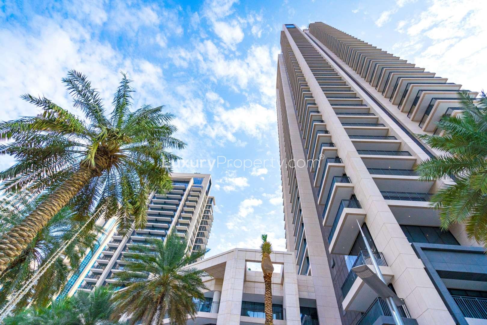 "Modern Boulevard Crescent apartment tower in Downtown Dubai with palm trees and blue sky.",Modern kitchen in two-bedroom apartment, Boulevard Crescent, Downtown Dubai, for sale