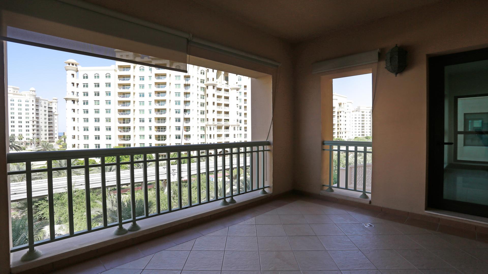 Luxurious apartment view, Golden Mile, Palm Jumeirah, Dubai, with lush greenery and skyline