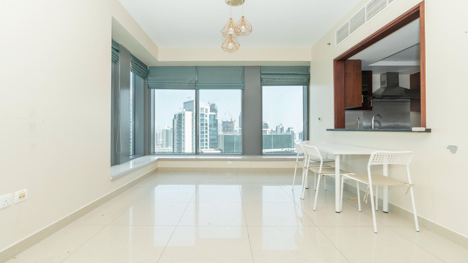 "Bright dining area with Burj Khalifa view in 29 Boulevard apartment, Downtown Dubai.","Spacious dining area in high-floor apartment, 29 Boulevard, Downtown Dubai, with modern kitchen view.",High-floor apartment view of Burj Khalifa from 29 Boulevard, Downtown Dubai