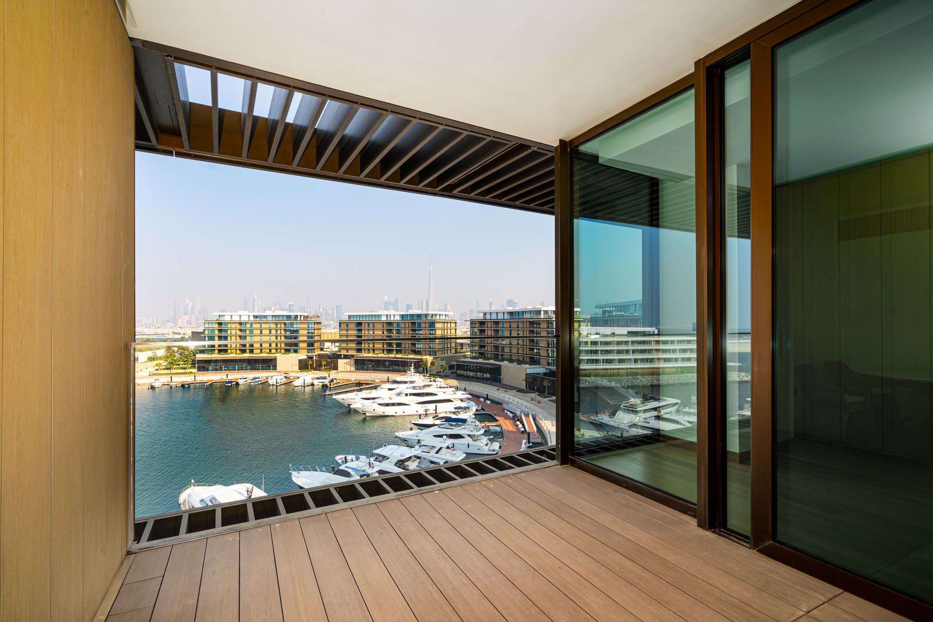 "Bright waterfront view from luxury apartment at Bulgari Residences, Jumeirah Bay.","Stunning waterfront view from Bulgari Residences apartment balcony, Jumeirah Bay Island, Dubai.",Exquisite waterfront apartment view at Bulgari Residences, Jumeirah Bay, Dubai marina skyline