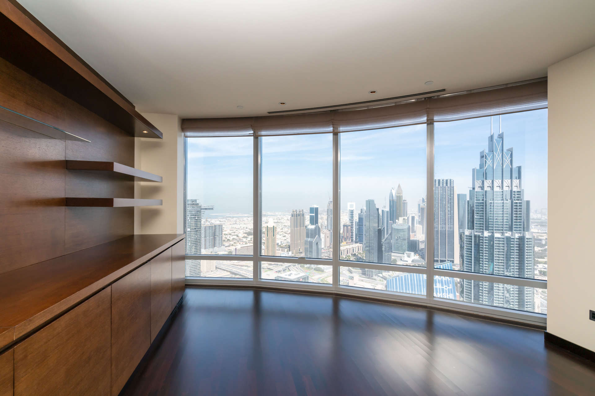 Spacious living area with kitchen and skyline views in Burj Khalifa apartment, Downtown Dubai