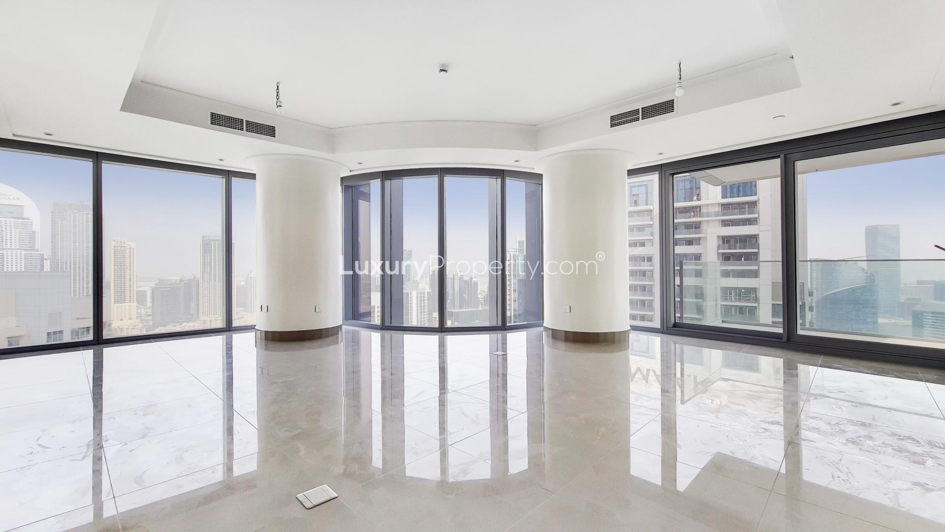 "Balcony view from apartment in Burj Khalifa Area, Downtown Dubai, overlooking city skyline.",Bright, spacious apartment interior with floor-to-ceiling windows, downtown Dubai skyline view