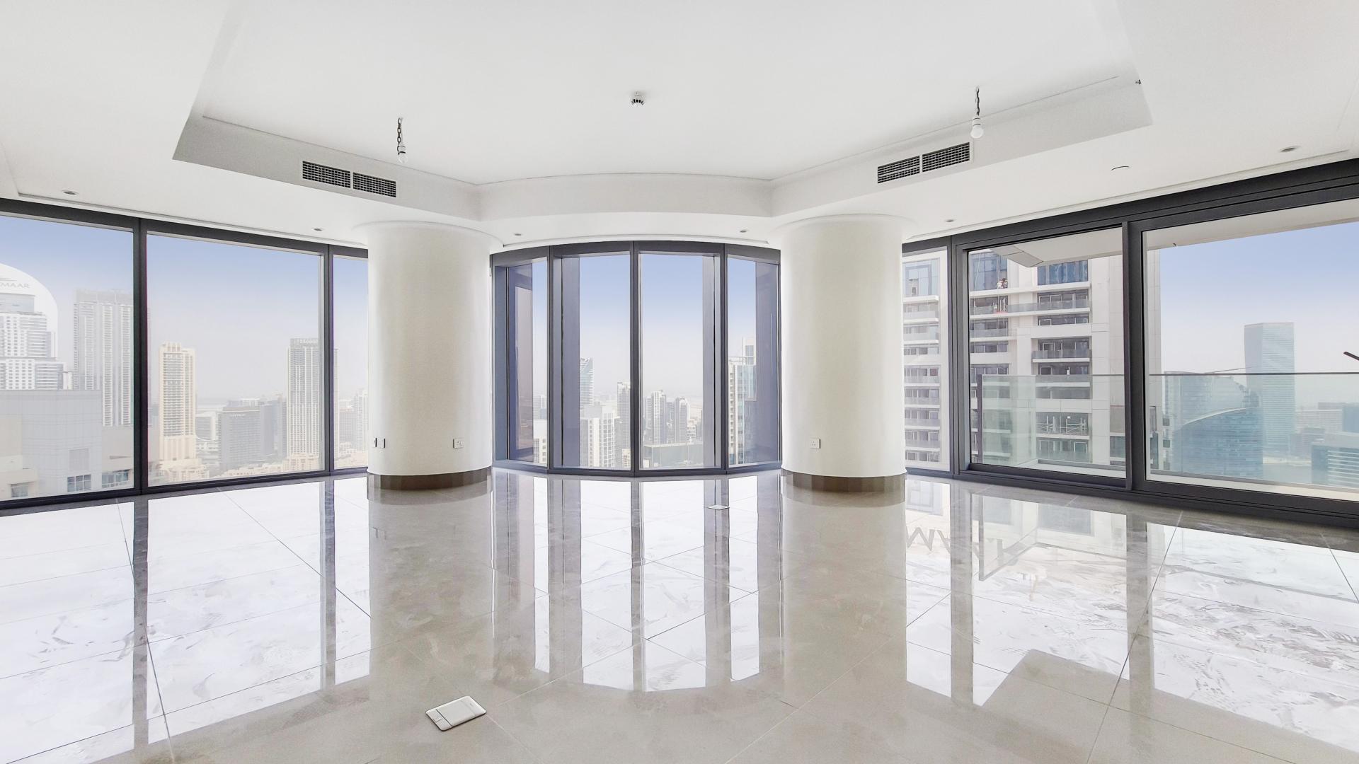 "Balcony view from apartment in Burj Khalifa Area, Downtown Dubai, overlooking city skyline.",Bright, spacious apartment interior with floor-to-ceiling windows, downtown Dubai skyline view