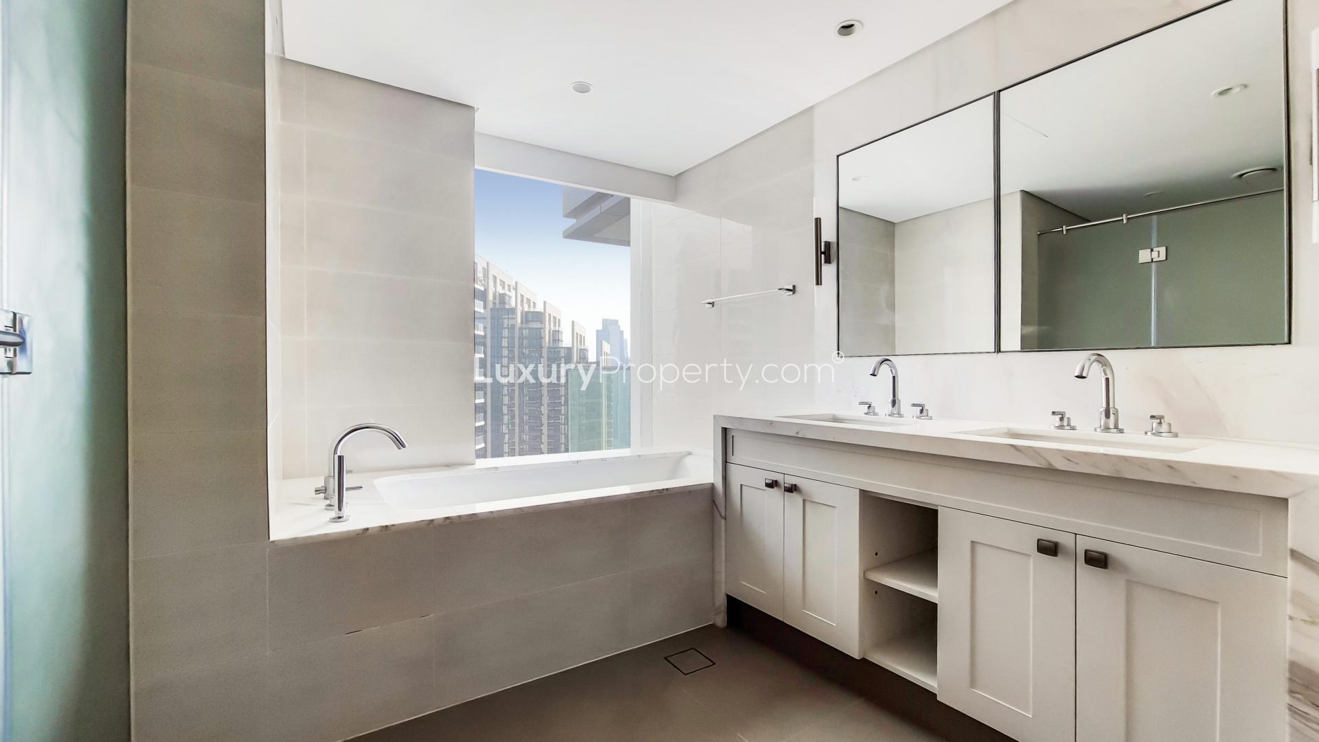 "Modern bathroom in Downtown Dubai apartment with city view, dual sinks, and bathtub.",Brand new apartment in Burj Khalifa Area with spacious living room and large windows