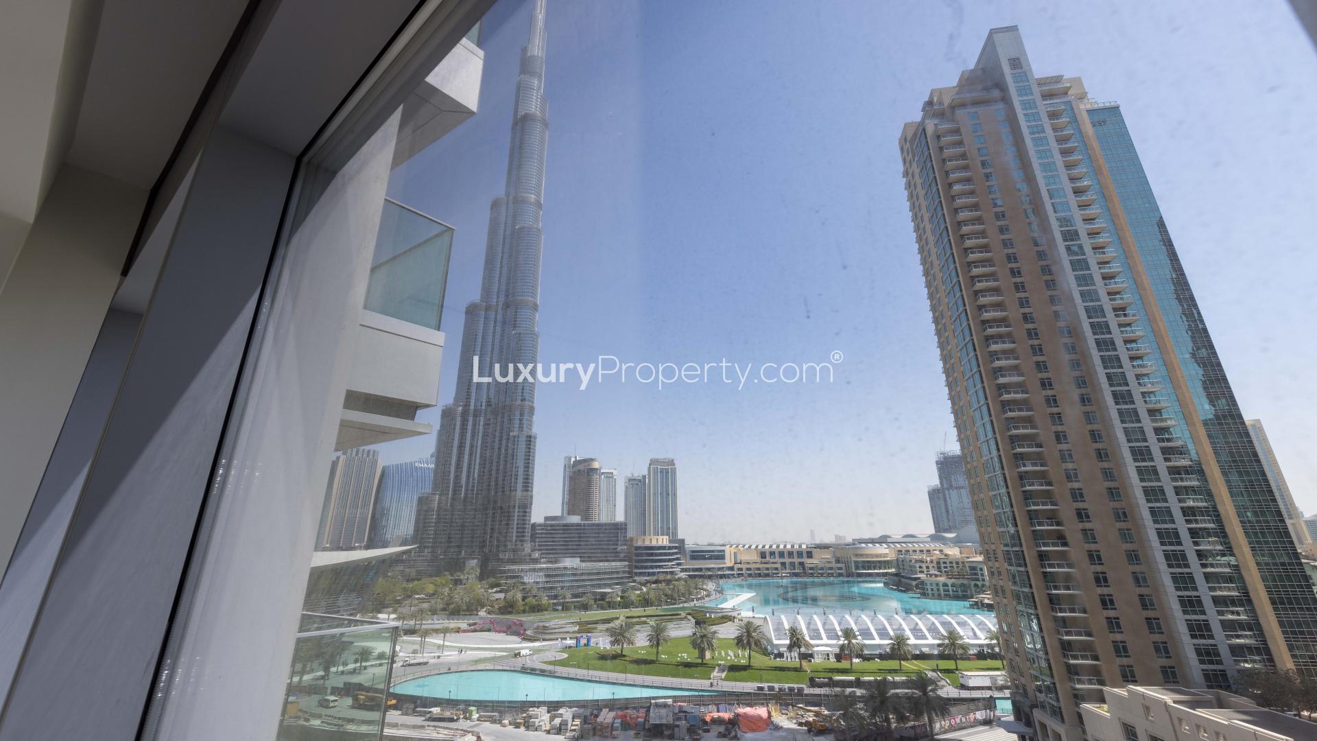 "Bright, spacious living area in brand new Downtown Dubai apartment, Burj Khalifa Area.","View from spacious Downtown Dubai apartment overlooking Burj Khalifa and surrounding skyline.",Modern kitchen with wooden cabinetry in Downtown Dubai apartment for sale, Burj Khalifa area