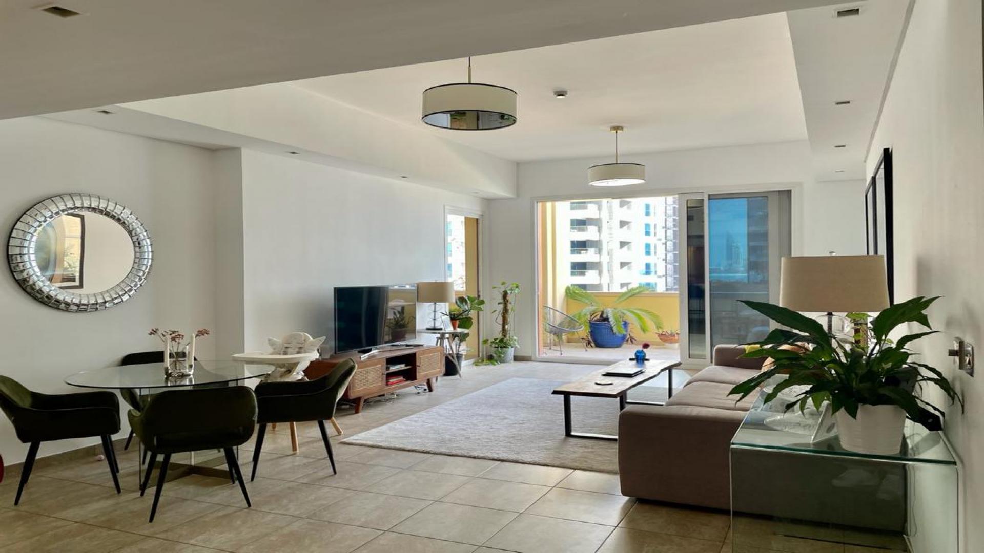 Elegant living room in 2-bedroom Palm Jumeirah apartment, featuring modern decor and open layout