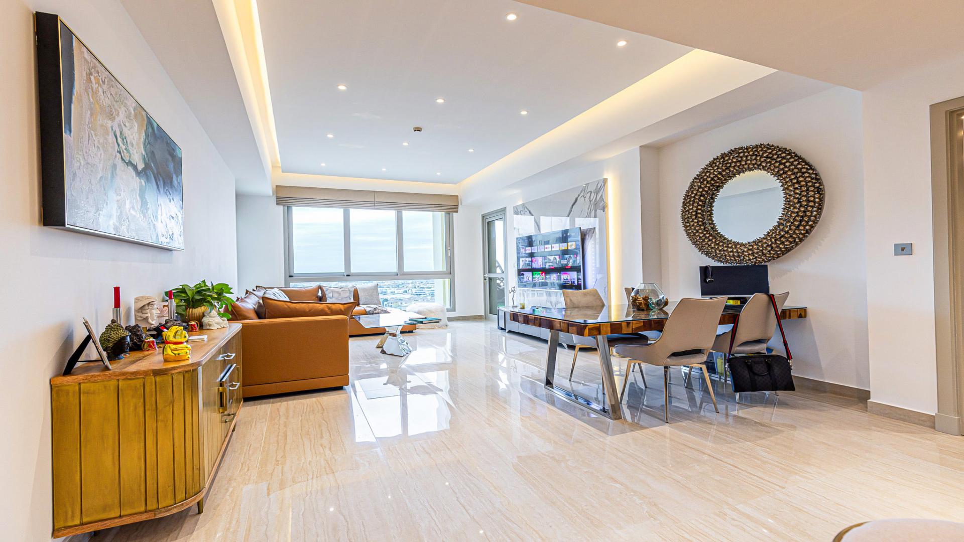 Luxury furnished balcony in Marina Residences apartment, Palm Jumeirah, with seating and lush decor